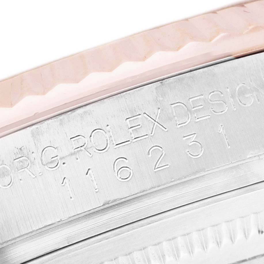 The image shows a close-up angle of the bezel and engraved case side of a Rolex Datejust 116231 Men's Steel and Gold (two tone) Silver Dial watch.