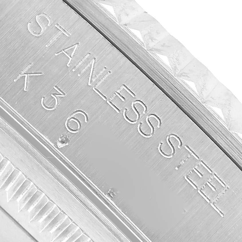 The image shows a close-up of a stainless steel Rolex Datejust 16234 Men's Stainless Steel Silver Dial watch case side with engraved text.