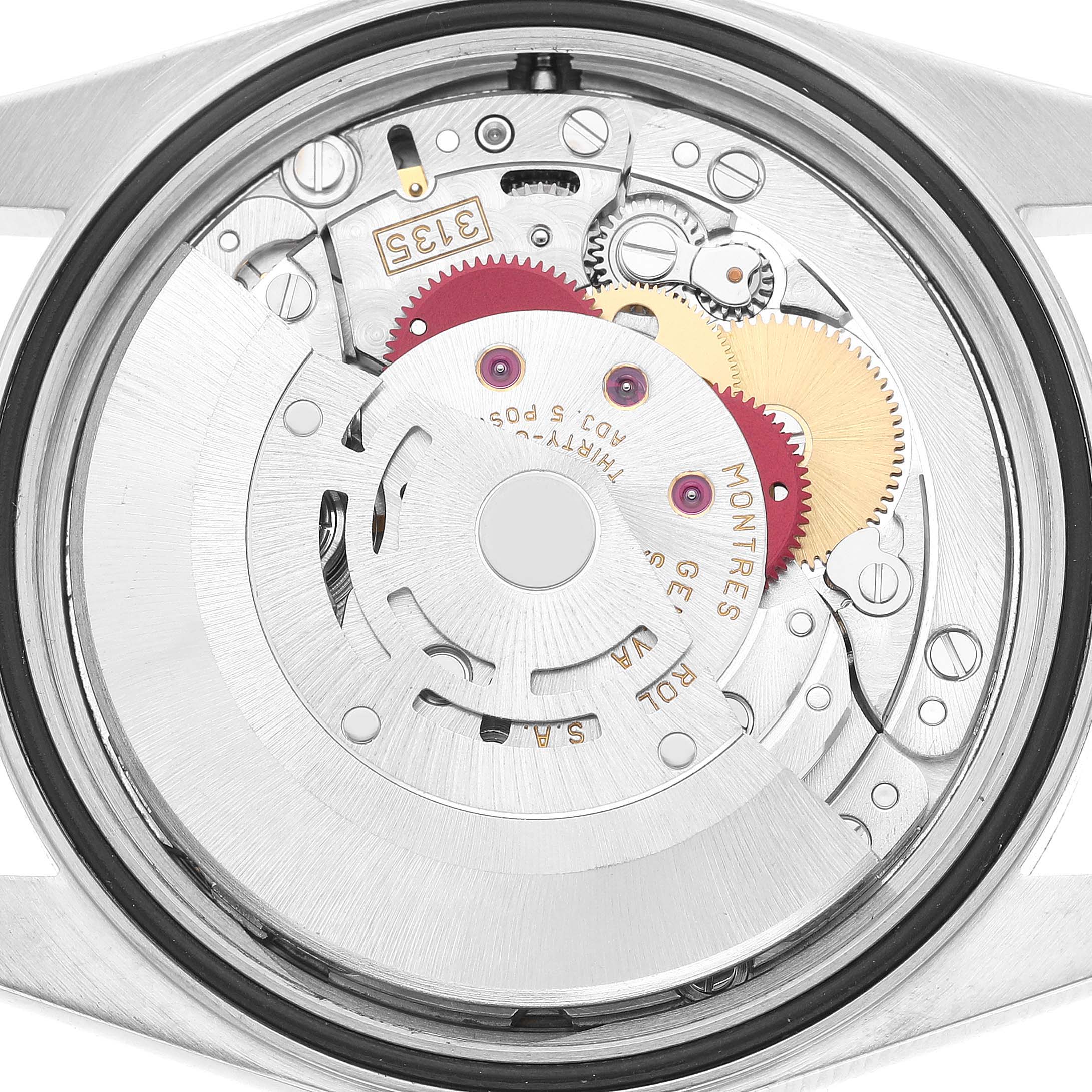 The image shows a close-up of the Rolex Datejust 16234 Men's Stainless Steel Silver Dial watch movement from the back, highlighting its intricate mechanical parts.