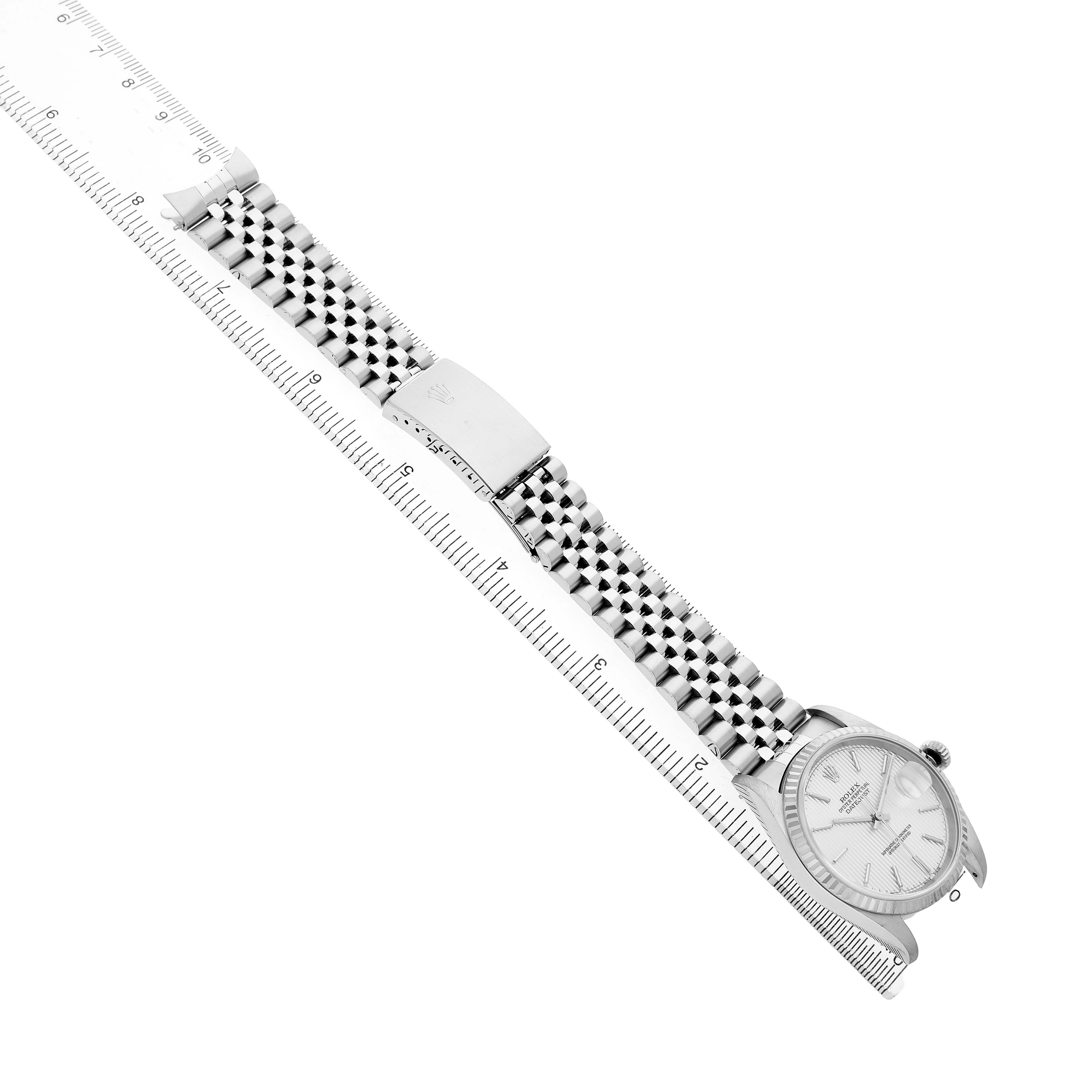 The image shows a Rolex Datejust 16234 Men's Stainless Steel Silver Dial watch from a top-down angle with a full view of the face, bracelet, and clasp.