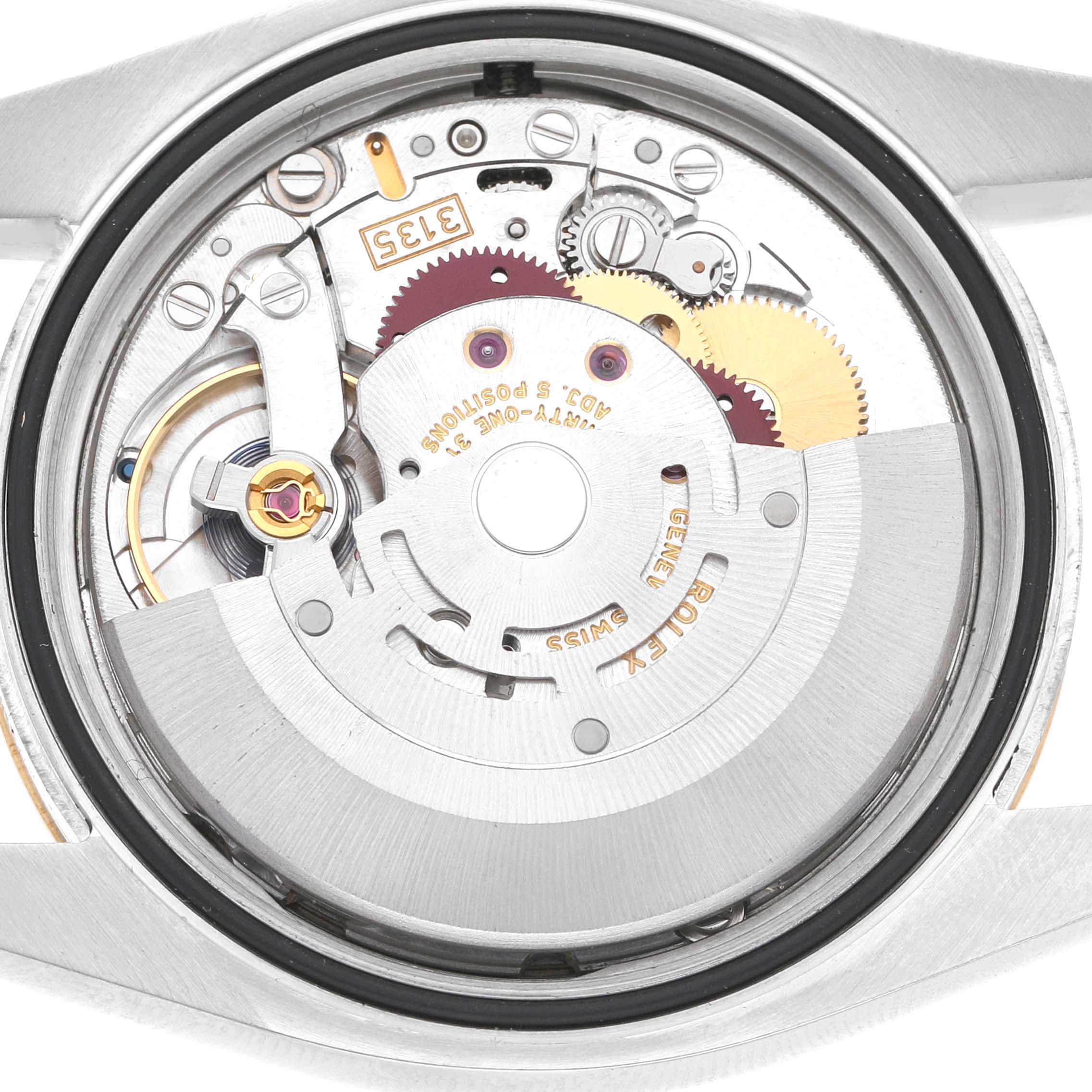 The image shows the movement of a Rolex Datejust 116203 Men's Steel and Gold (two tone) Champagne Dial watch from a rear angle, highlighting the intricate gears and components.