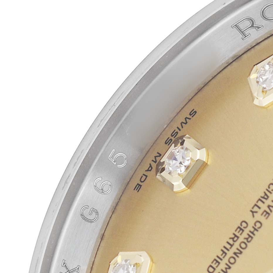 The image shows a close-up of a Rolex Datejust 116203 Men's Steel and Gold (two tone) Champagne Dial's dial edge, focusing on diamond hour markers and part of the bezel.