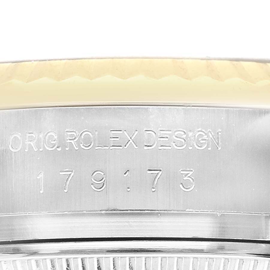 The image shows a close-up of the side of a Rolex Datejust 179173 Women's Steel and Gold (two tone) Silver Dial watch, featuring the engraved model number.