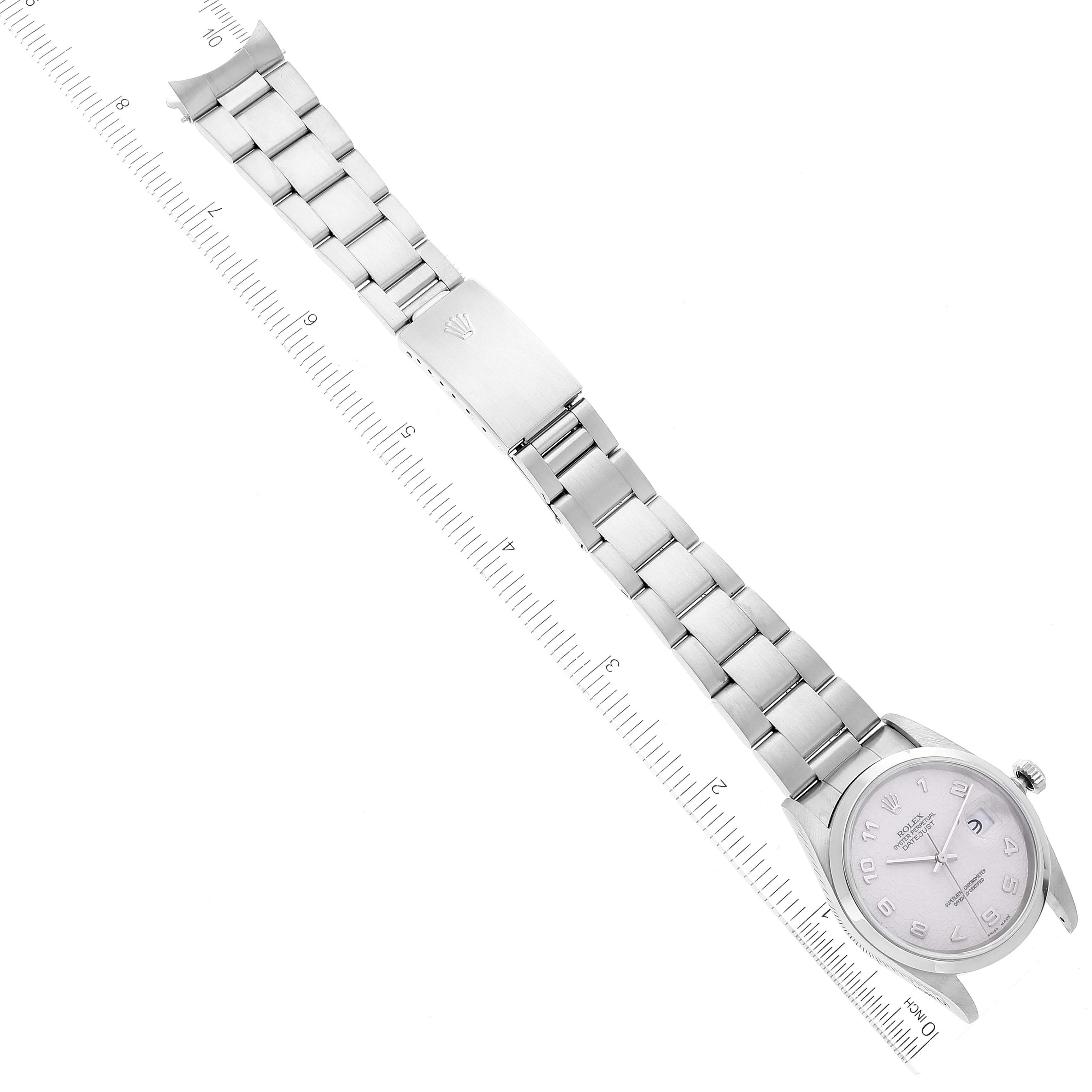 The image shows a top-down view of a Rolex Datejust 16200 Men's Stainless Steel Silver Dial 16200 Men's Stainless Steel Silver Dial watch, displaying its face, bracelet, and clasp, with a ruler for scale.
