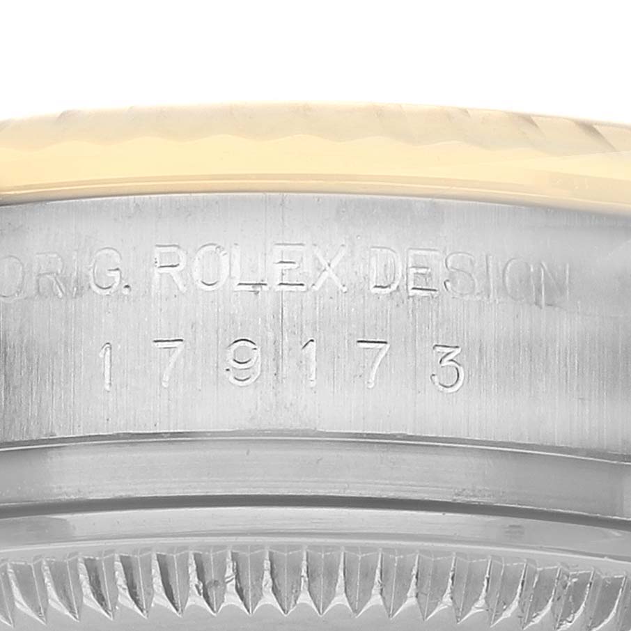 The image shows a close-up of the side of a Rolex Datejust 179173 Women's Steel and Gold (two tone) White Dial watch, highlighting the engraved model number.