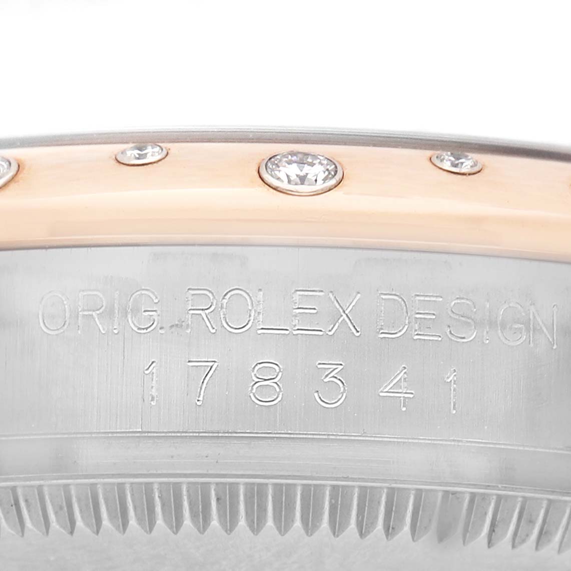 The image shows a close-up of the Rolex Datejust 178341 Women's Steel and Gold (two tone) Black Dial watch case side, displaying diamonds on the bezel and engraved design details.