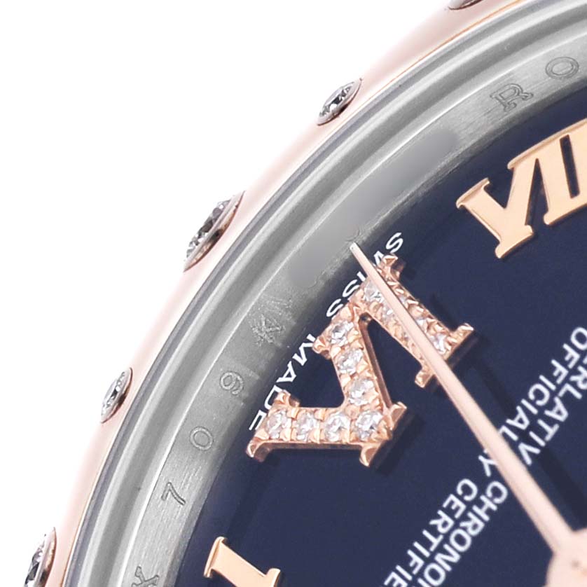 This is a close-up of a Rolex Datejust 178341 Women's Steel and Gold (two tone) Black Dial watch, showing the bezel, dial with Roman numerals, and part of the hour hand.