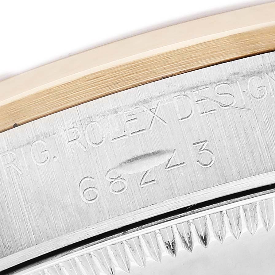 The image shows a close-up of the serial number engraving on the side of a Rolex Datejust 68243 Women's Steel and Gold (two tone) White Dial model.