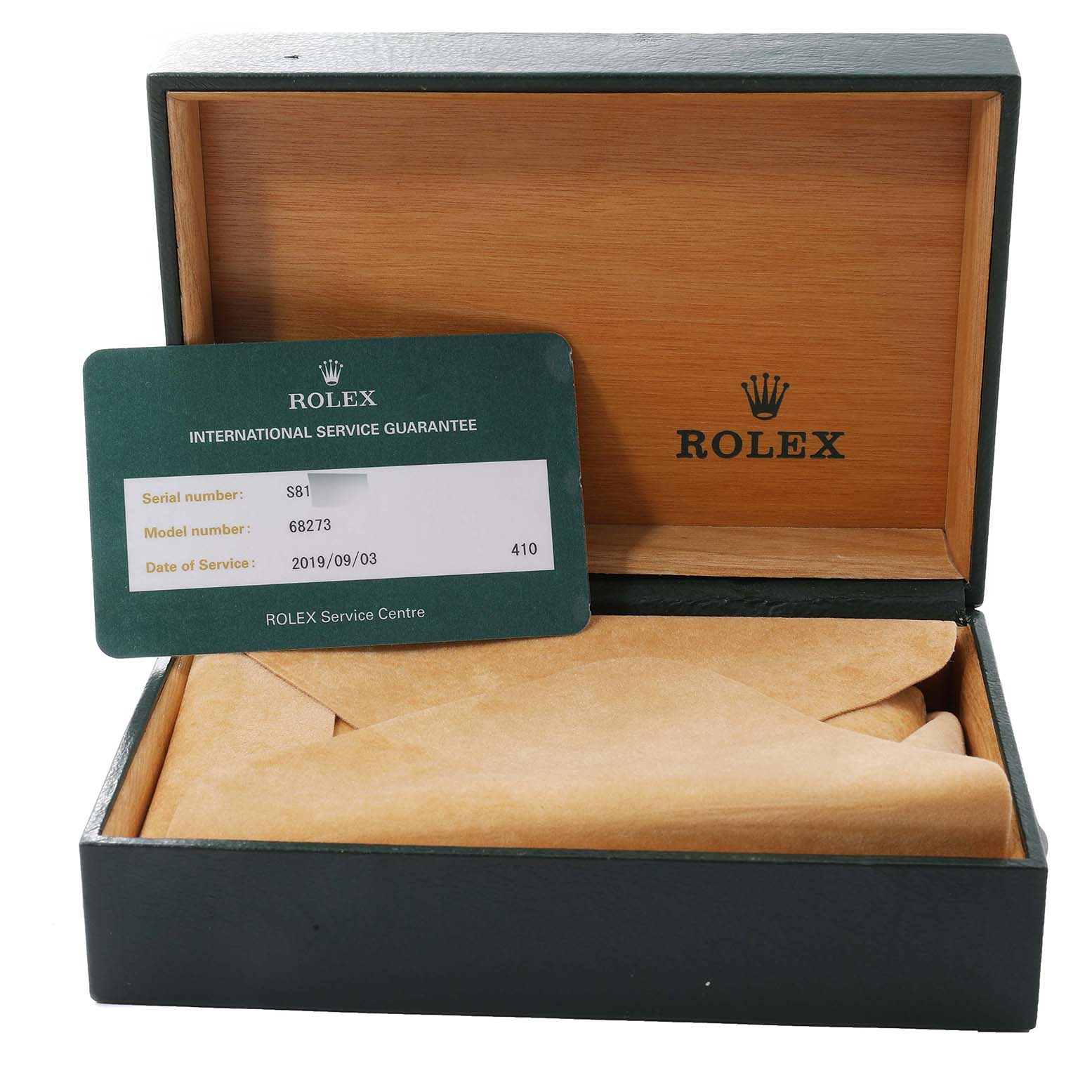 This image shows an open Rolex Datejust 68273 Women's Steel and Gold (two tone) Black Dial 68273 Women's Steel and Gold (two tone) Black Dial watch box with an International Service Guarantee card placed inside.