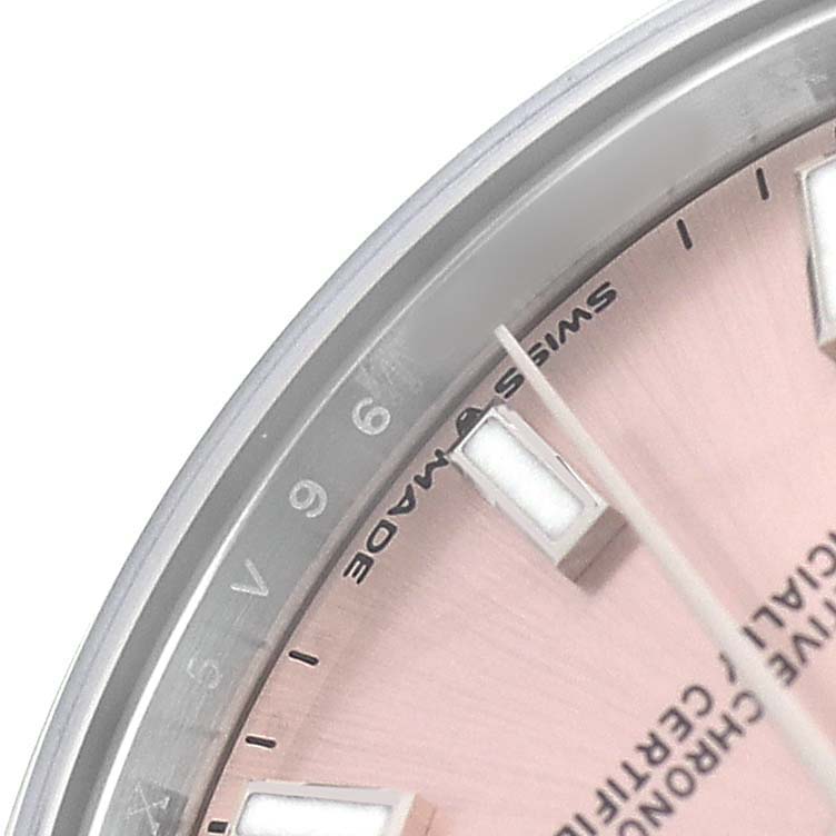 The image shows a close-up of the dial and case of a Mid-Size Rolex watch with visible indices and part of the bezel.