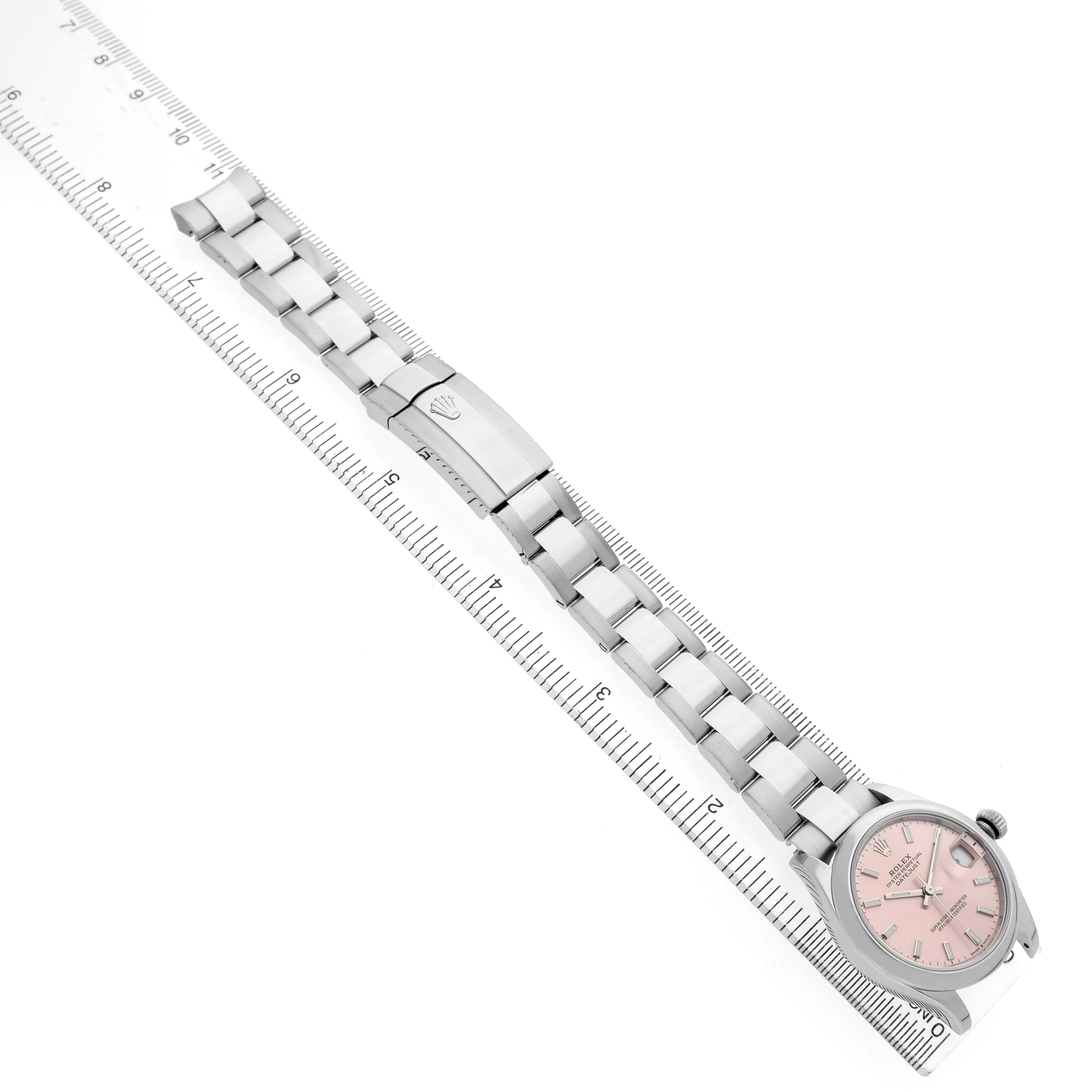 The Rolex Mid-Size 278240 Women's Stainless Steel Pink Dial watch is shown diagonally with bracelet and clasp visible against a ruler for scale.