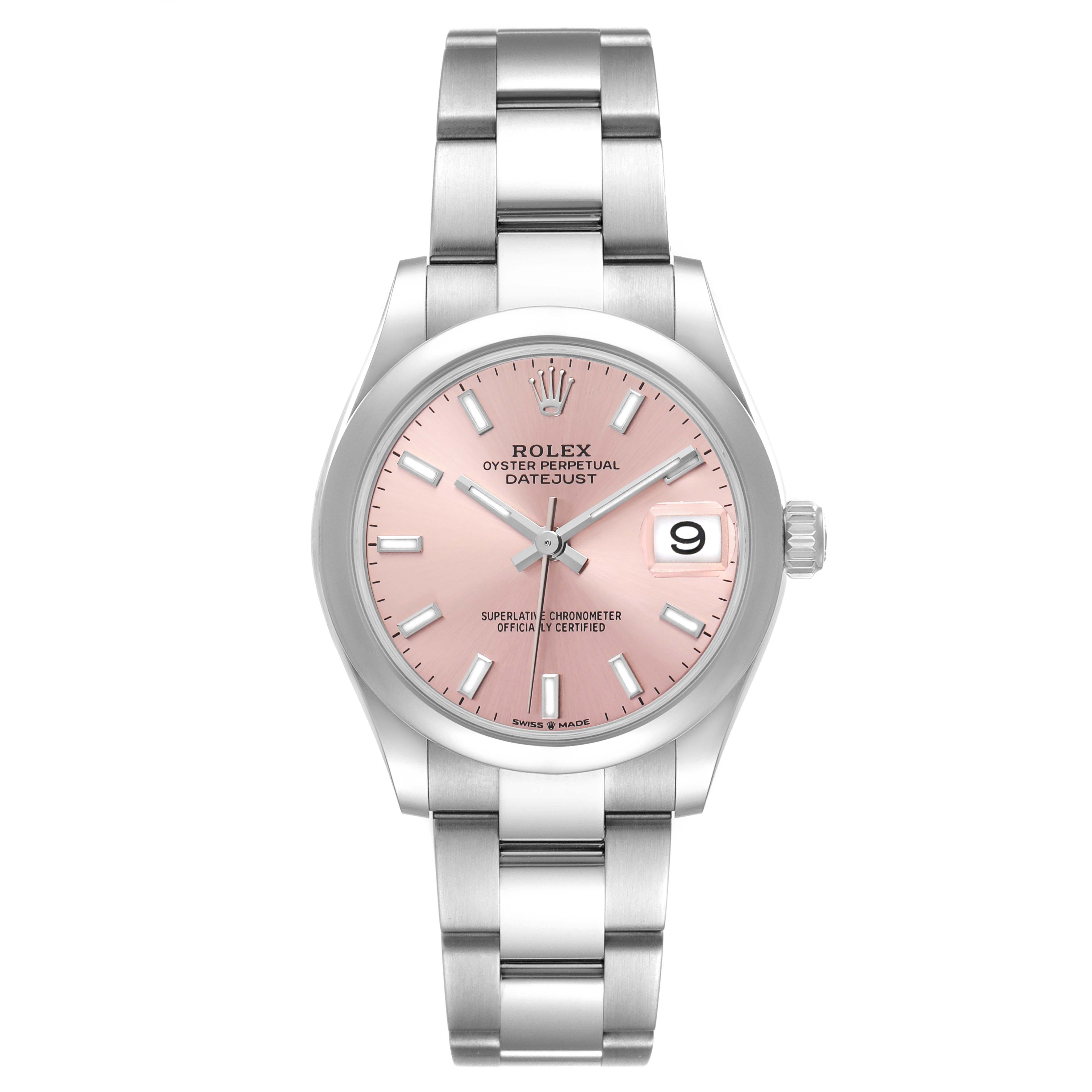 The Rolex Datejust Mid-Size is shown from a front angle, displaying its pink dial, metal bracelet, and date window at 3 o'clock.