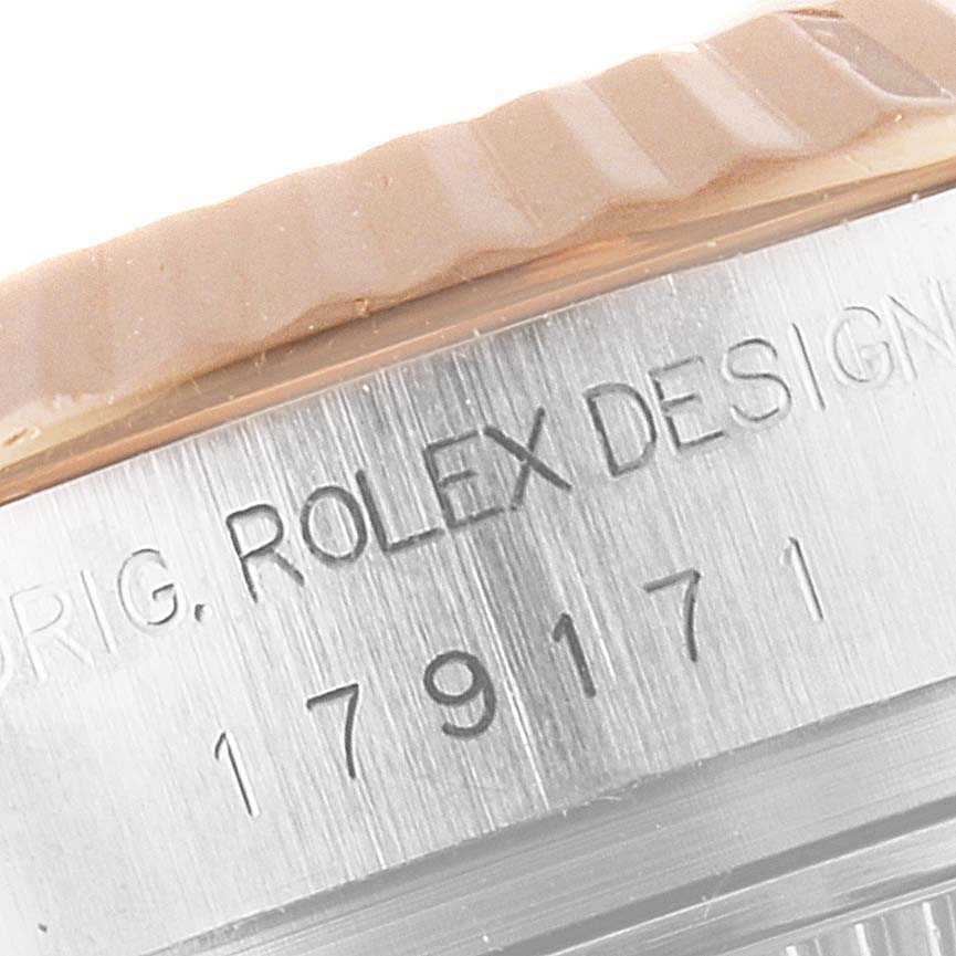 This close-up image shows the engraved side of the bezel and serial number on a Rolex Datejust 179171 Women's Steel and Gold (two tone) Silver Dial 179171 Women's Steel and Gold (two tone) Silver Dial watch.