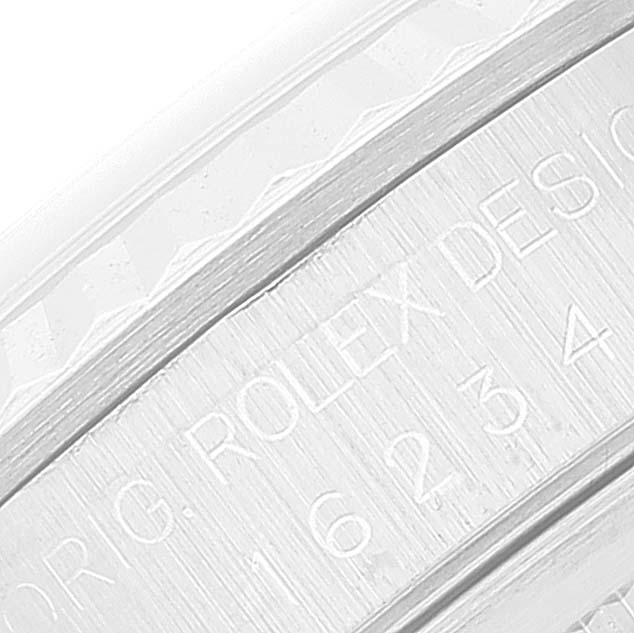 The image shows the engraved inner bezel of a Rolex Datejust 16234 Men's Stainless Steel Silver Dial 16234 Men's Stainless Steel Silver Dial watch, highlighting part of the watch's serial information.