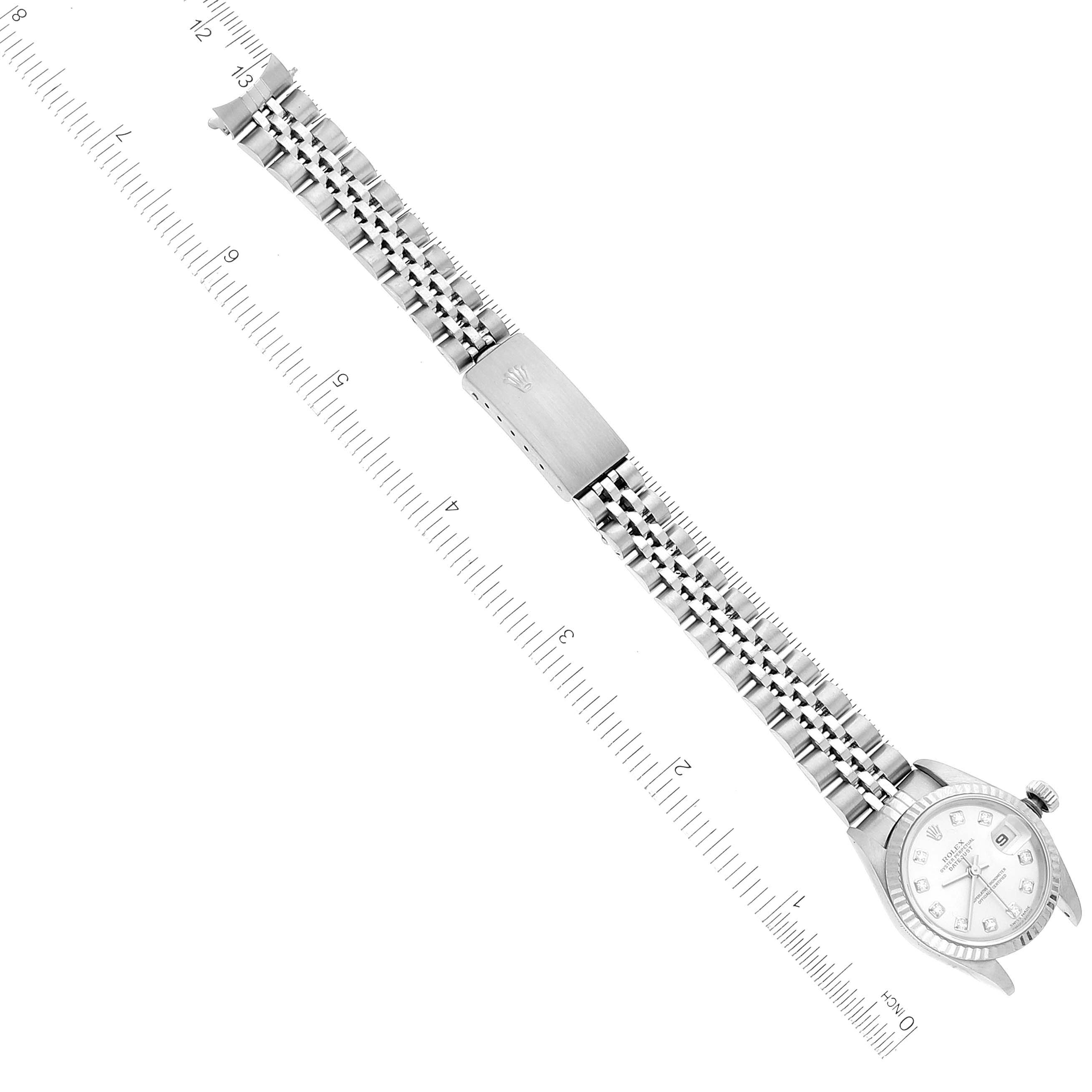 The image shows a steel Rolex Datejust 79174 Women's Stainless Steel Silver Dial 79174 Women's Stainless Steel Silver Dial watch positioned horizontally with the face on the left and a bracelet with a clasp.