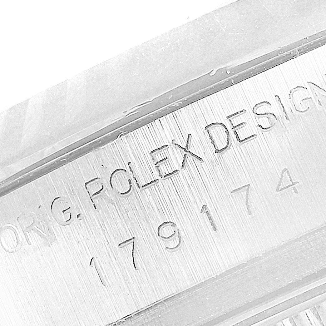 The image shows a close-up of the engraved serial number on the side of a Rolex Datejust 179174 Women
s Stainless Steel White Dial 179174 Women
s Stainless Steel White Dial watch case.