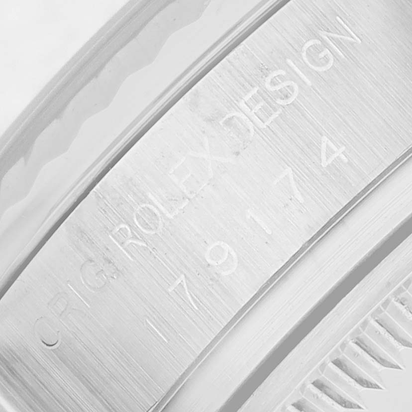 The image shows a close-up of the inner bezel and serial number engraving on the Rolex Datejust 179174 Women's Stainless Steel White Dial watch.