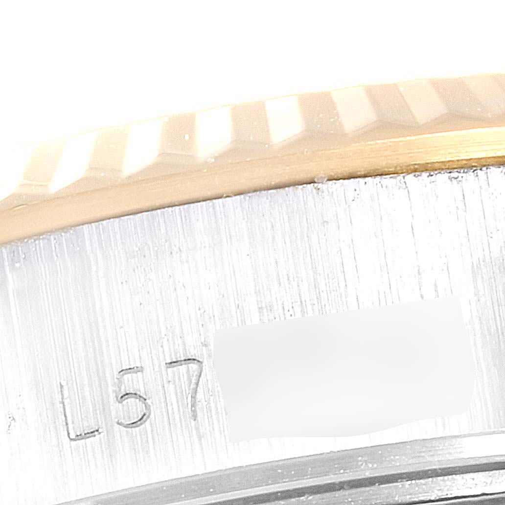 The image shows a close-up of the side of a Rolex Datejust 69173 Women's Steel and Gold (two tone) Champagne Dial 69173 Women's Steel and Gold (two tone) Champagne Dial watch, highlighting the fluted bezel, case, and part of the serial number engraving.