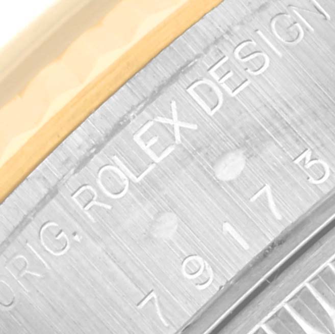 This is a close-up view of the Rolex Datejust 79173 Women's Steel and Gold (two tone) Blue Dial 79173 Women's Steel and Gold (two tone) Blue Dial model, focusing on the engraved bezel marking.