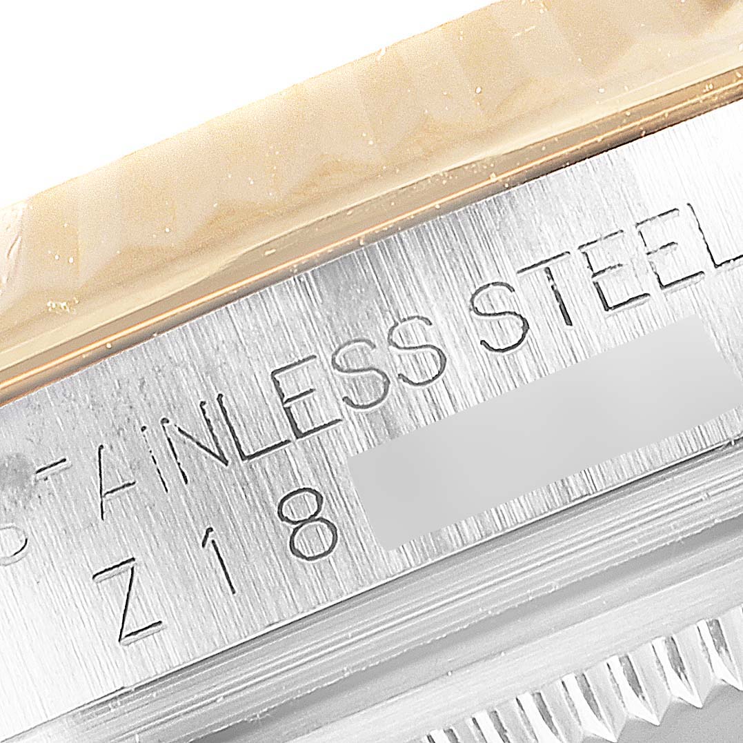 Close-up of the serial number and "STAINLESS STEEL" engraving on a Rolex Datejust 116233 Men's Steel and Gold (two tone) Blue Dial 116233 Men's Steel and Gold (two tone) Blue Dial watch bezel.
