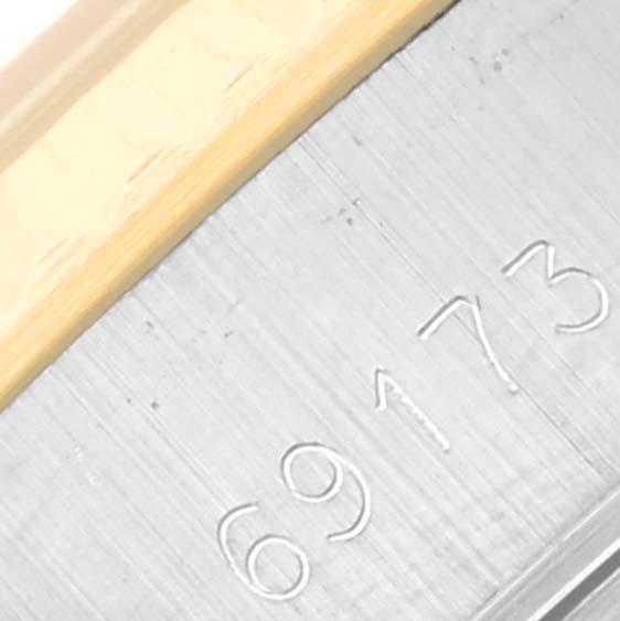 This image shows a close-up of the serial number 69173 on the bracelet of a Rolex Datejust 69173 Women's Steel and Gold (two tone) Champagne Dial 69173 Women's Steel and Gold (two tone) Champagne Dial watch.