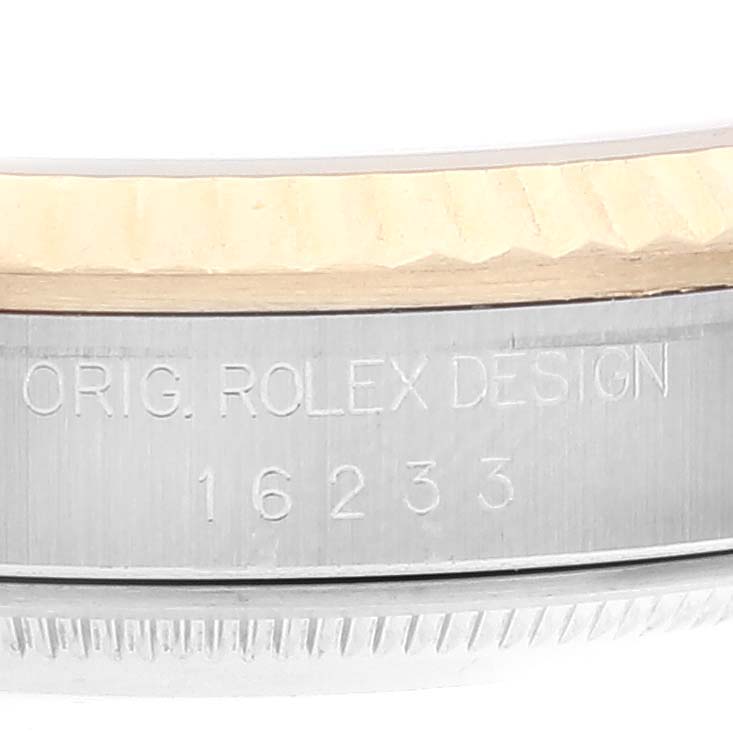 The image shows a close-up of the model number and part of the bezel on a Rolex Datejust 16233 Men's Steel and Gold (two tone) Champagne Dial 16233 Men's Steel and Gold (two tone) Champagne Dial watch.