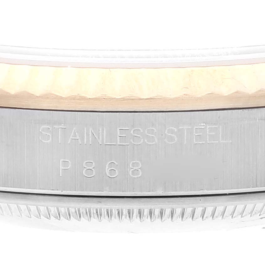 This image shows a close-up of the stainless steel side of the bezel and case back of a Rolex Datejust 16233 Men's Steel and Gold (two tone) Champagne Dial 16233 Men's Steel and Gold (two tone) Champagne Dial watch.