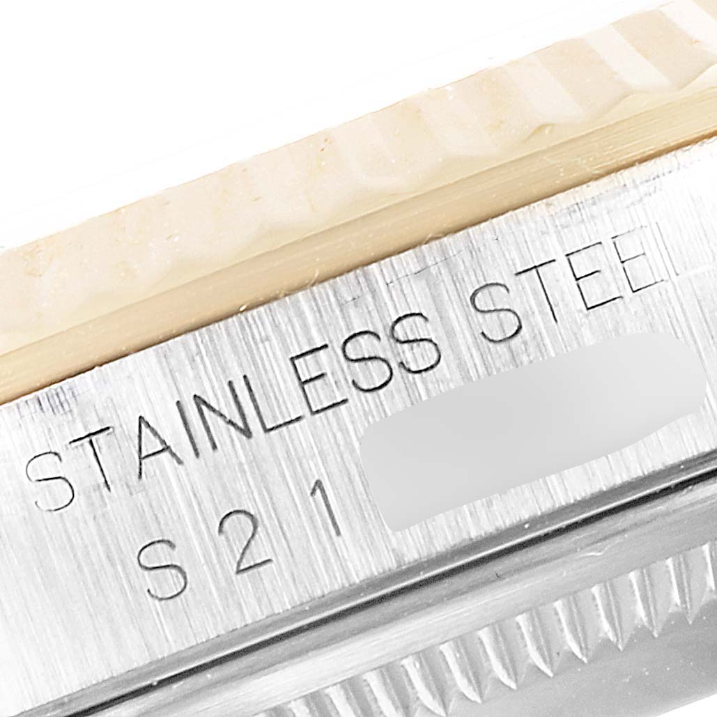 This close-up image shows the engraving of "STAINLESS STEEL" and a partial serial number on the Rolex Datejust 16233 Men's Steel and Gold (two tone) Beige Dial 16233 Men's Steel and Gold (two tone) Beige Dial watch bezel.