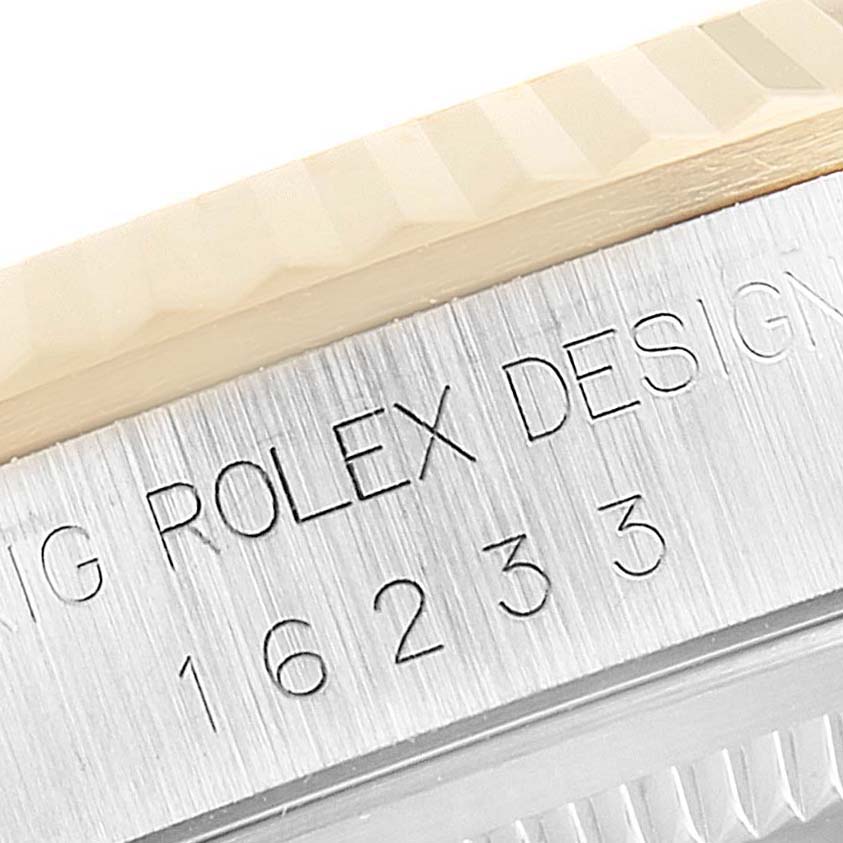 This is a close-up of the engraved bezel and case number of the Rolex Datejust 16233 Men's Steel and Gold (two tone) Beige Dial 16233 Men's Steel and Gold (two tone) Beige Dial watch.