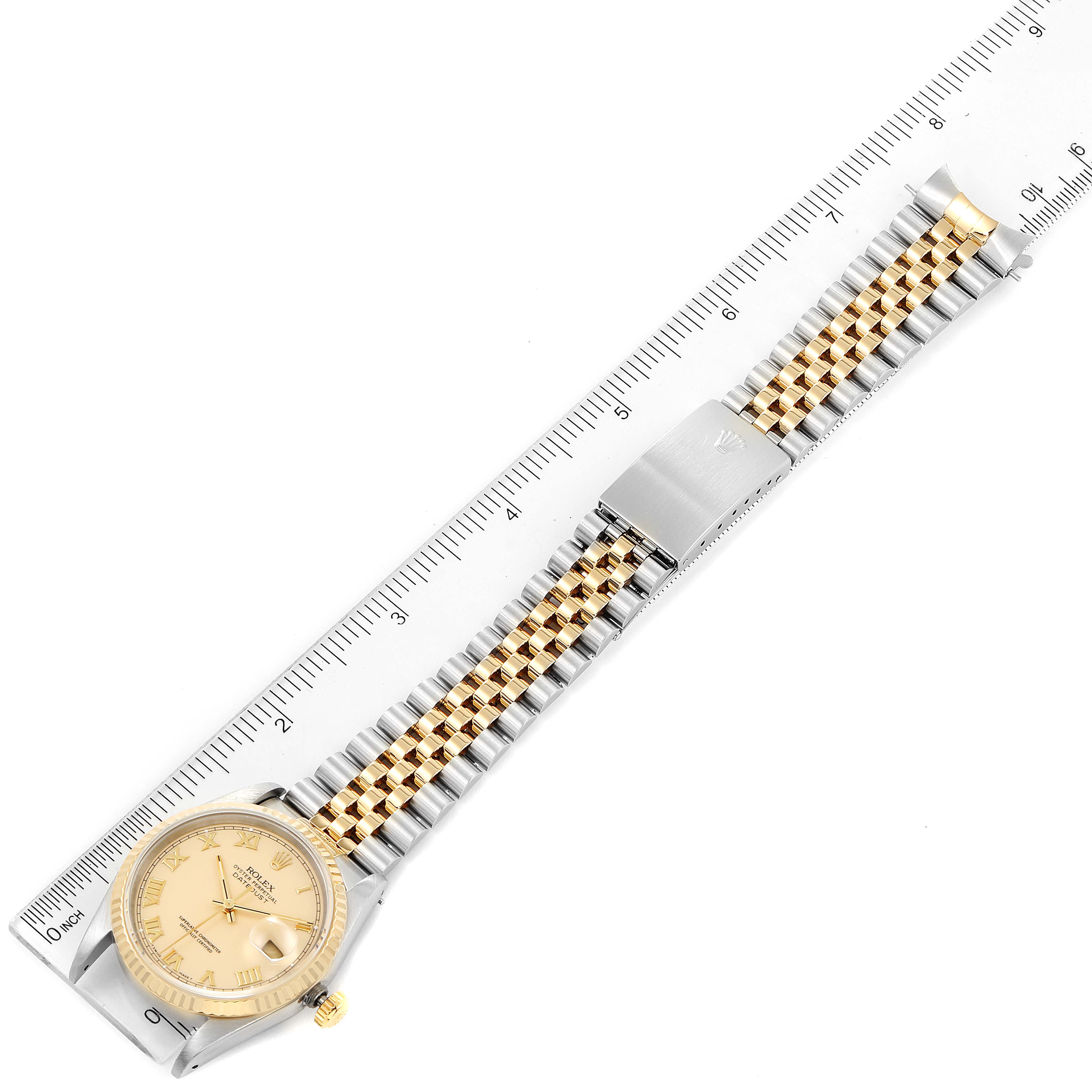 The image shows a Rolex Datejust 16233 Men's Steel and Gold (two tone) Beige Dial 16233 Men's Steel and Gold (two tone) Beige Dial watch laid flat with its bracelet fully extended next to a ruler for size reference.