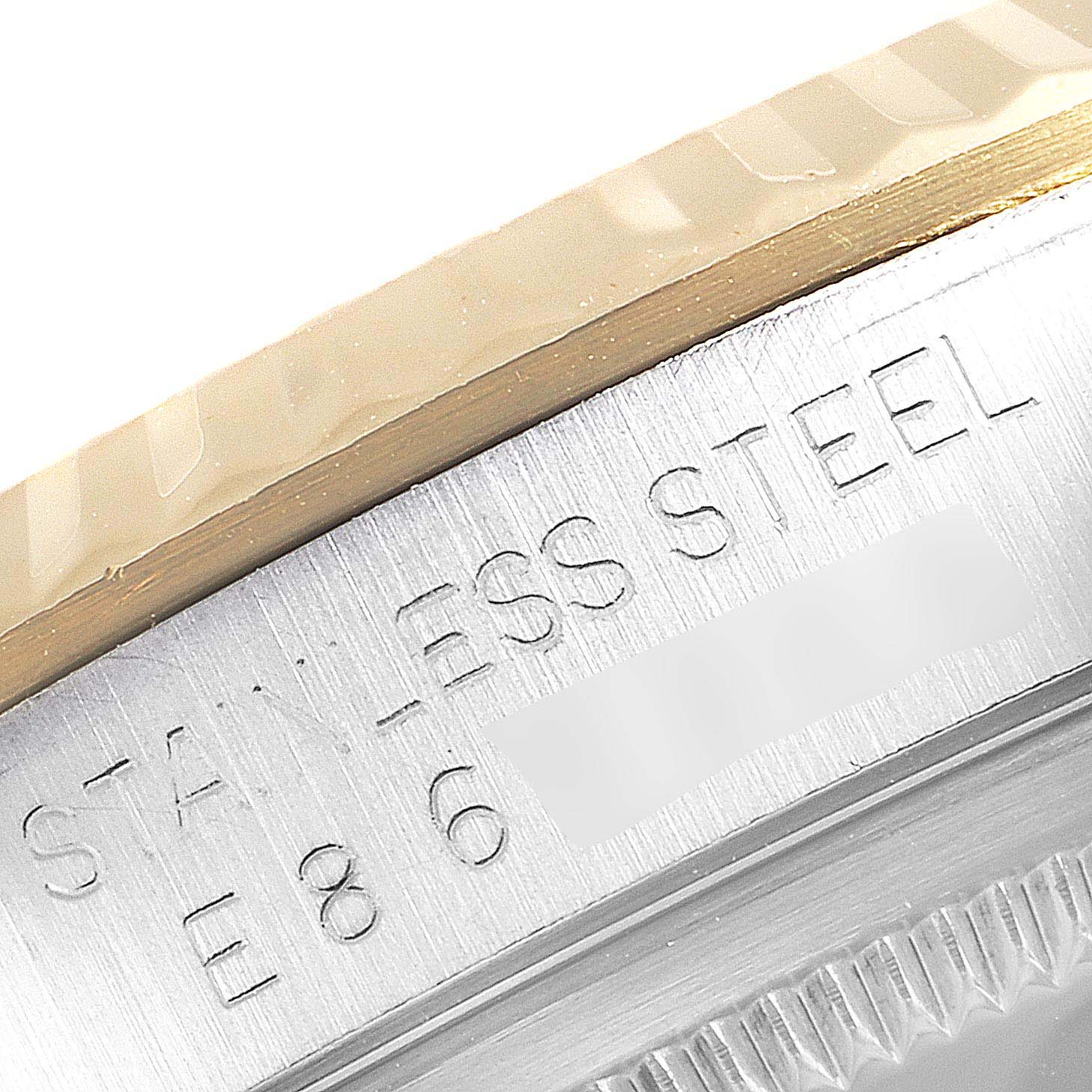 This image shows a close-up of the stainless steel case side and the edge of the bezel of a Rolex Datejust 16233 Men
s Steel and Gold (two tone) Silver Dial 16233 Men
s Steel and Gold (two tone) Silver Dial watch.