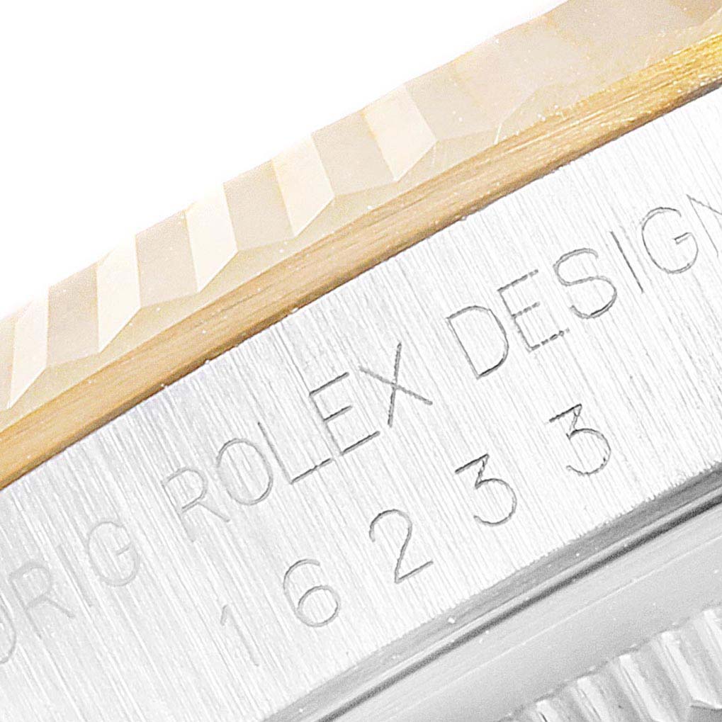 The image shows a close-up of the bezel and part of the case of a Rolex Datejust 16233 Men
s Steel and Gold (two tone) Silver Dial 16233 Men
s Steel and Gold (two tone) Silver Dial watch.