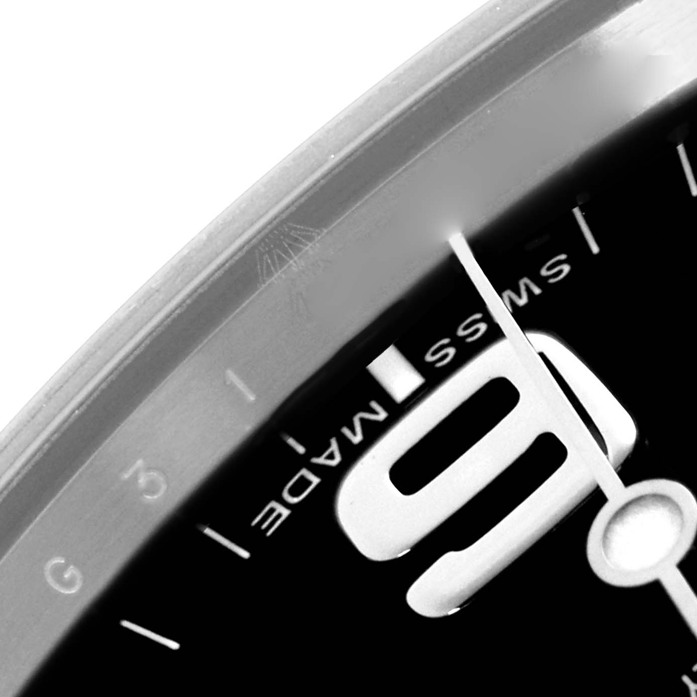 The image shows a close-up of the dial edge and numeral 9 of the Rolex Explorer 214270 Men's Stainless Steel Black Dial watch.