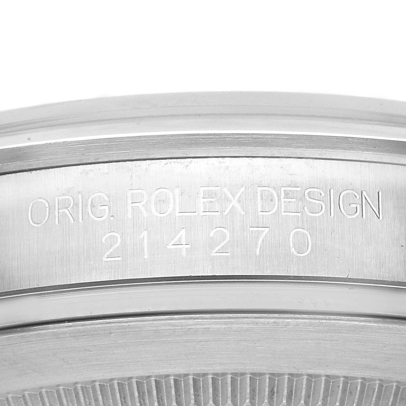 The image shows the side of a Rolex Explorer 214270 Men's Stainless Steel Black Dial watch, focusing on the engraved model number "214270" and "ORIG. ROLEX DESIGN."