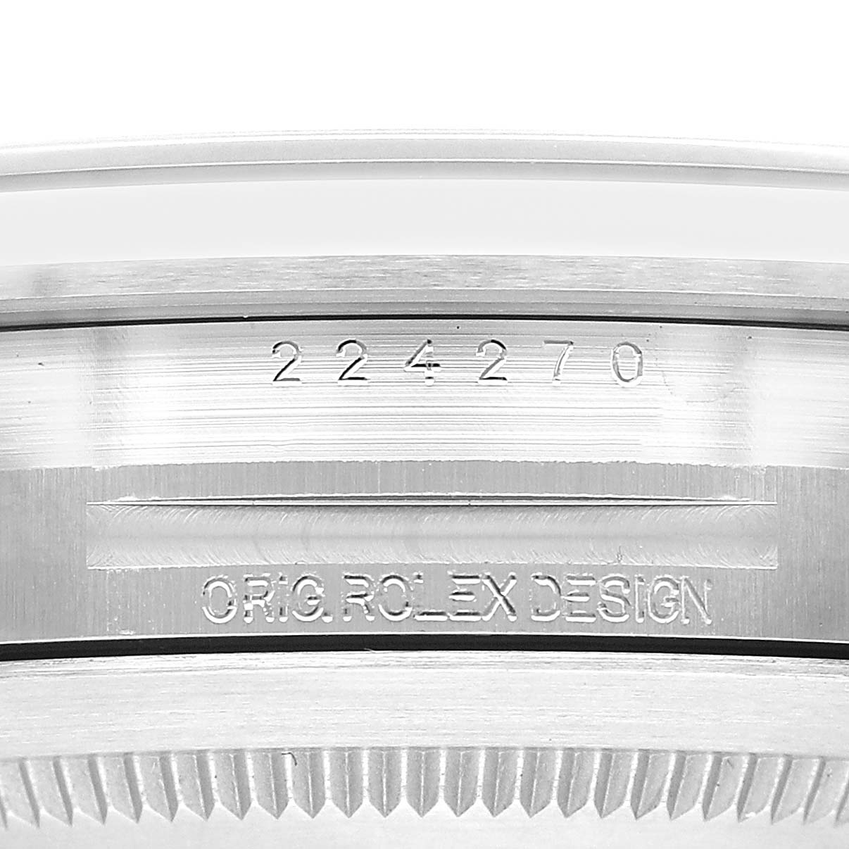 The image shows the engraved inner bezel with serial number and "ORIG. ROLEX DESIGN" text, viewed from a close-up angle on the Rolex Explorer 224270 Men's Stainless Steel Black Dial.