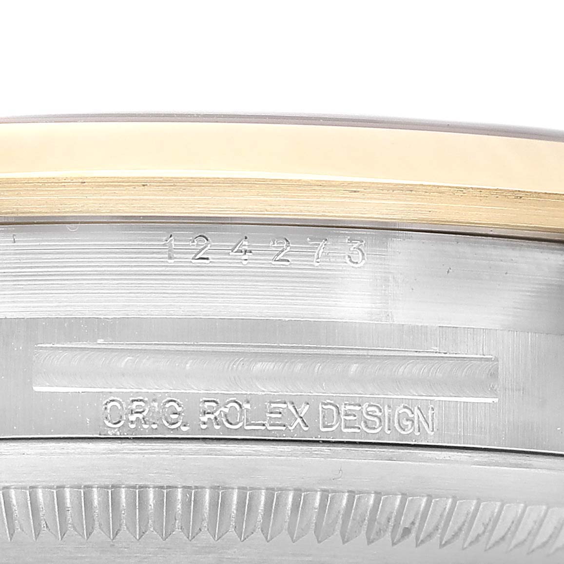 The image shows a close-up of the side edge of the Rolex Explorer 124273 Men's Steel and Gold (two tone) Black Dial, highlighting engraved text and the bezel detail.