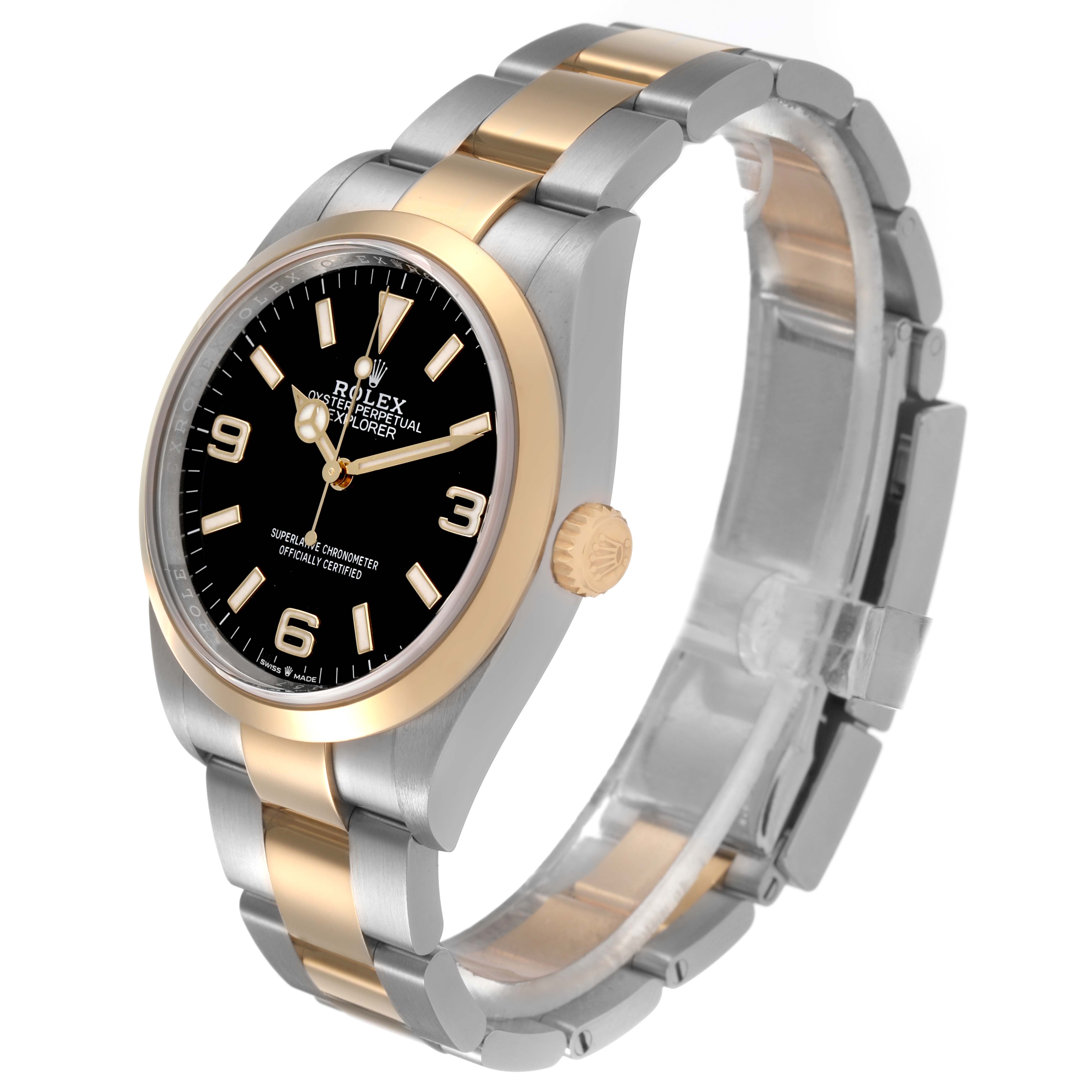 The Rolex Explorer 124273 Men's Steel and Gold (two tone) Black Dial watch is shown at a three-quarter angle, highlighting the dial, bezel, crown, and bracelet.