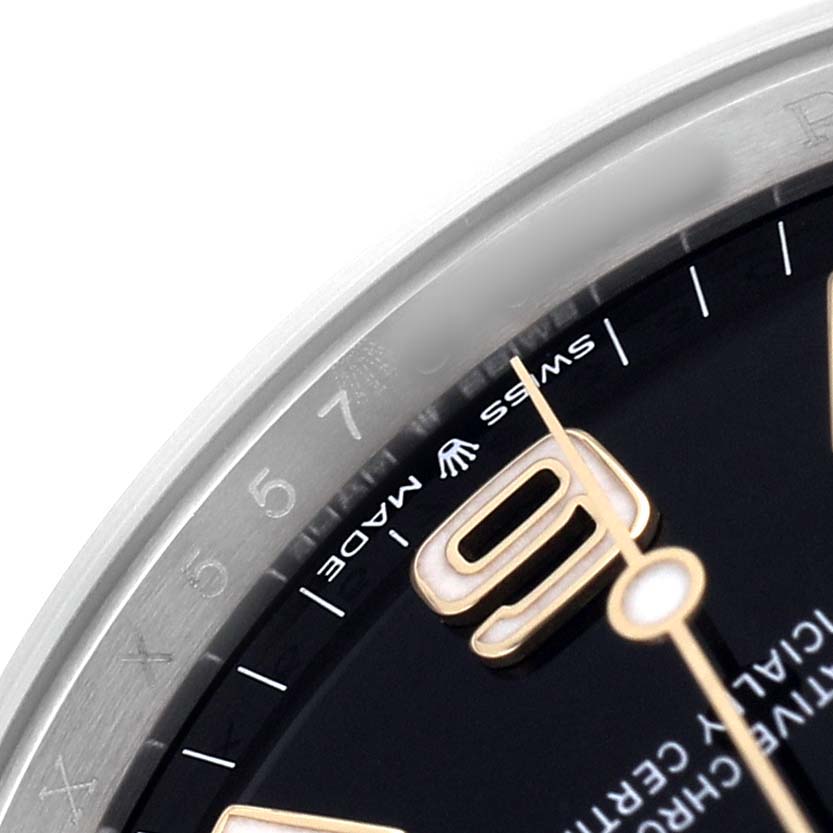 The image shows a close-up angled view of the dial and bezel of the Rolex Explorer 124273 Men's Steel and Gold (two tone) Black Dial, focusing on the "6" numeral and "Swiss Made" text.