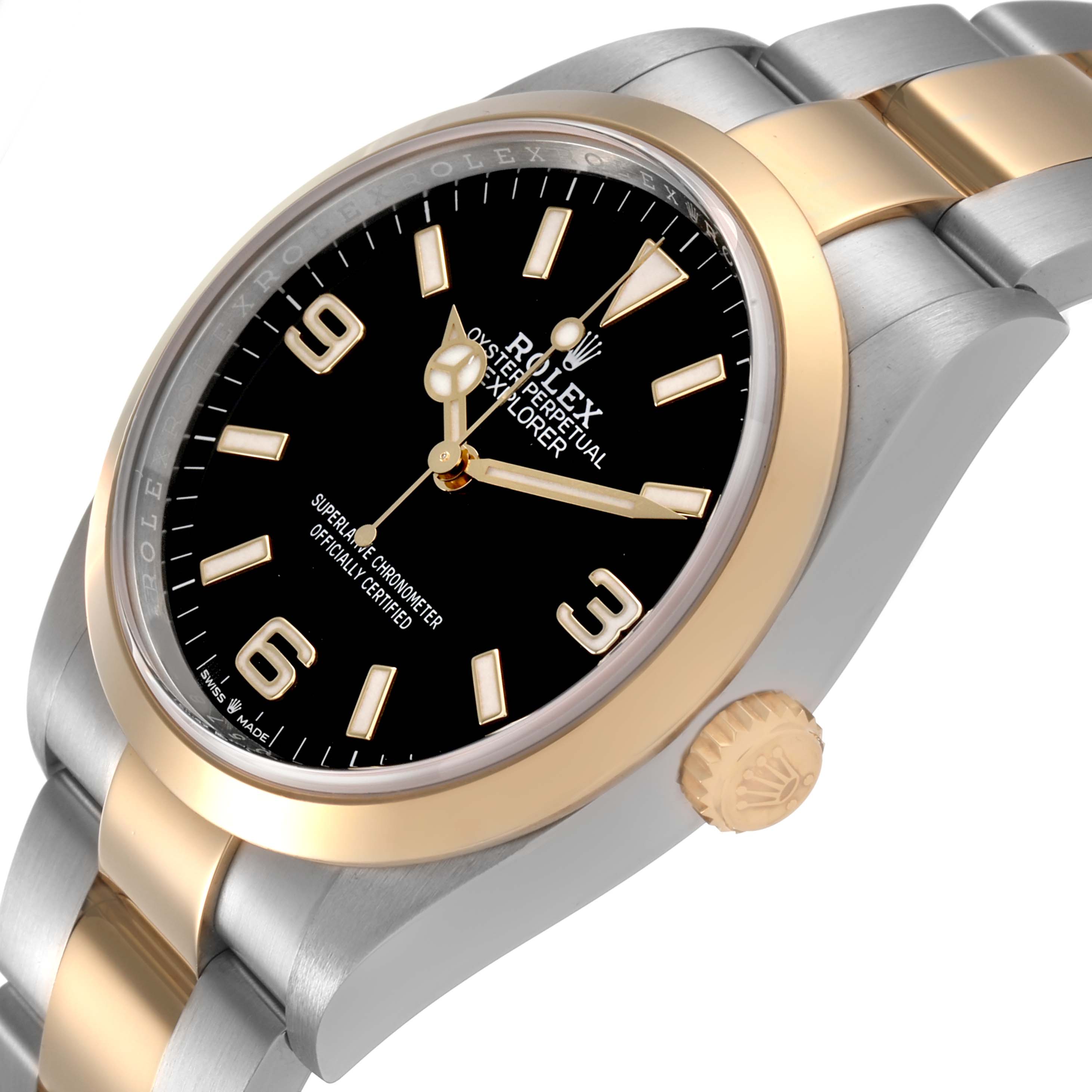 The image shows a Rolex Explorer 124273 Men's Steel and Gold (two tone) Black Dial watch at an angled side view, focusing on the bezel, dial, and crown.