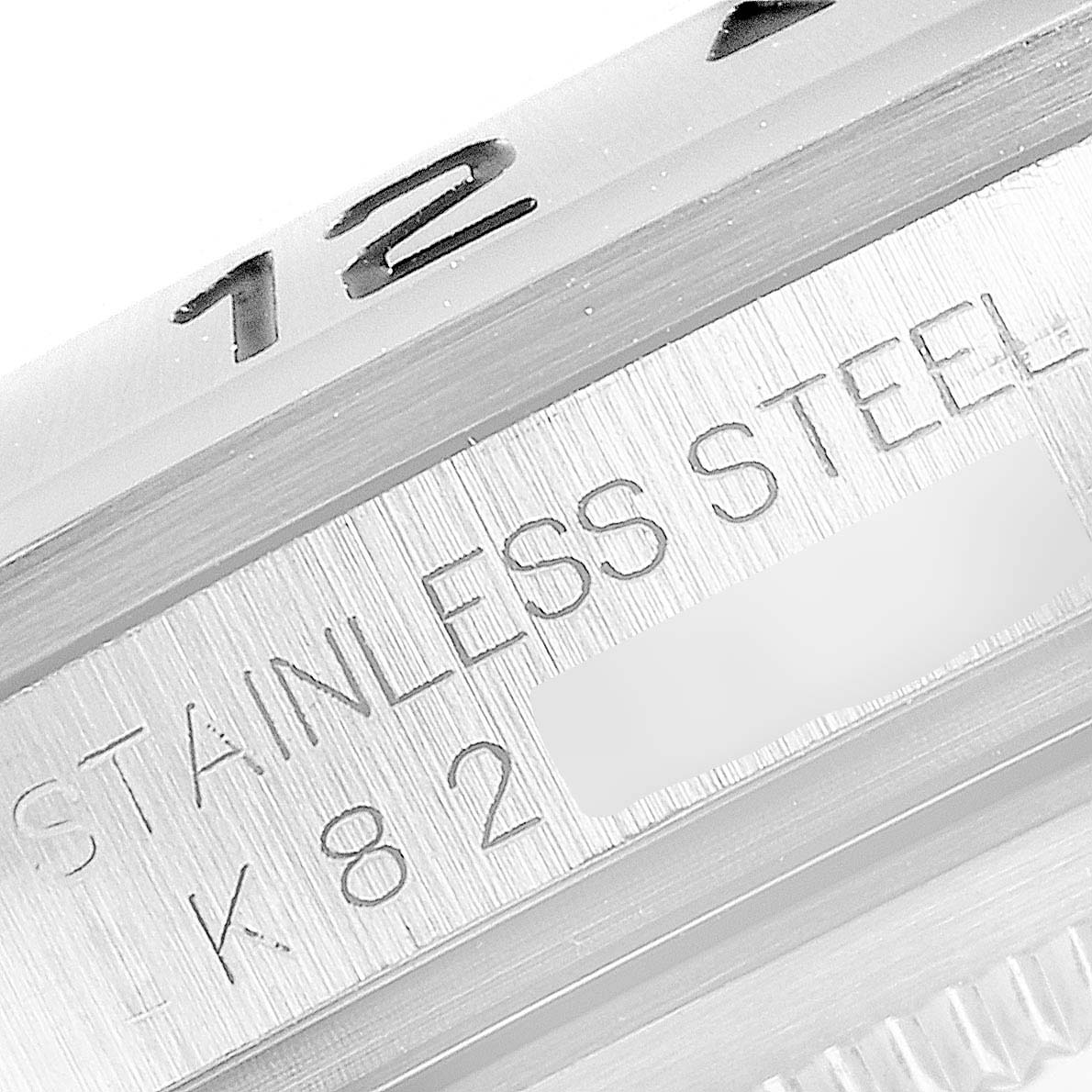 This close-up shows the bezel and engraving on the stainless steel case of the Rolex Explorer 16570 Men's Stainless Steel Black Dial 16570 Men's Stainless Steel Black Dial watch.