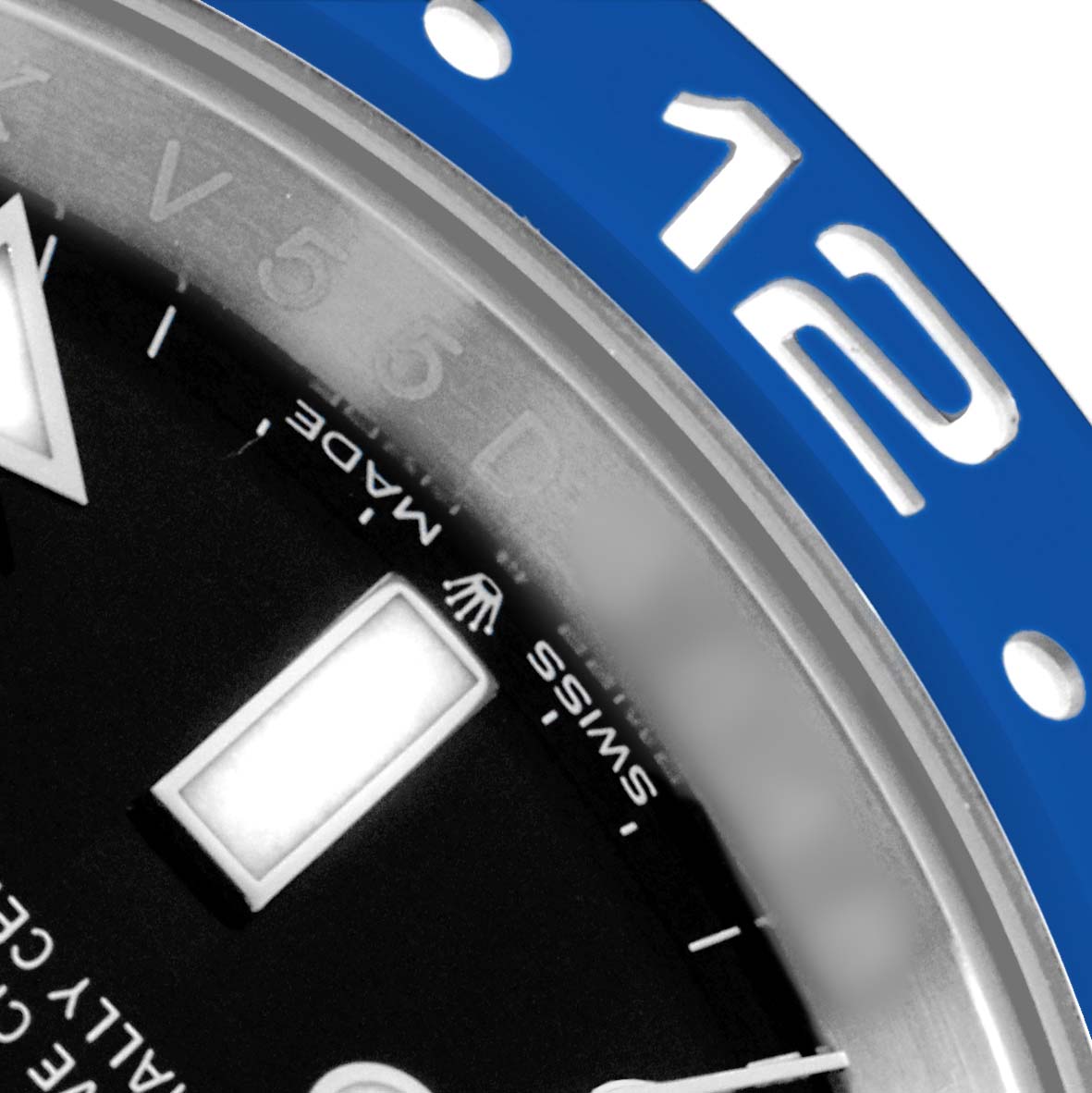 This close-up shows a partial view of the Rolex GMT-Master 126710 Men's Stainless Steel Black Dial's blue bezel, hour marker, and part of the dial text.