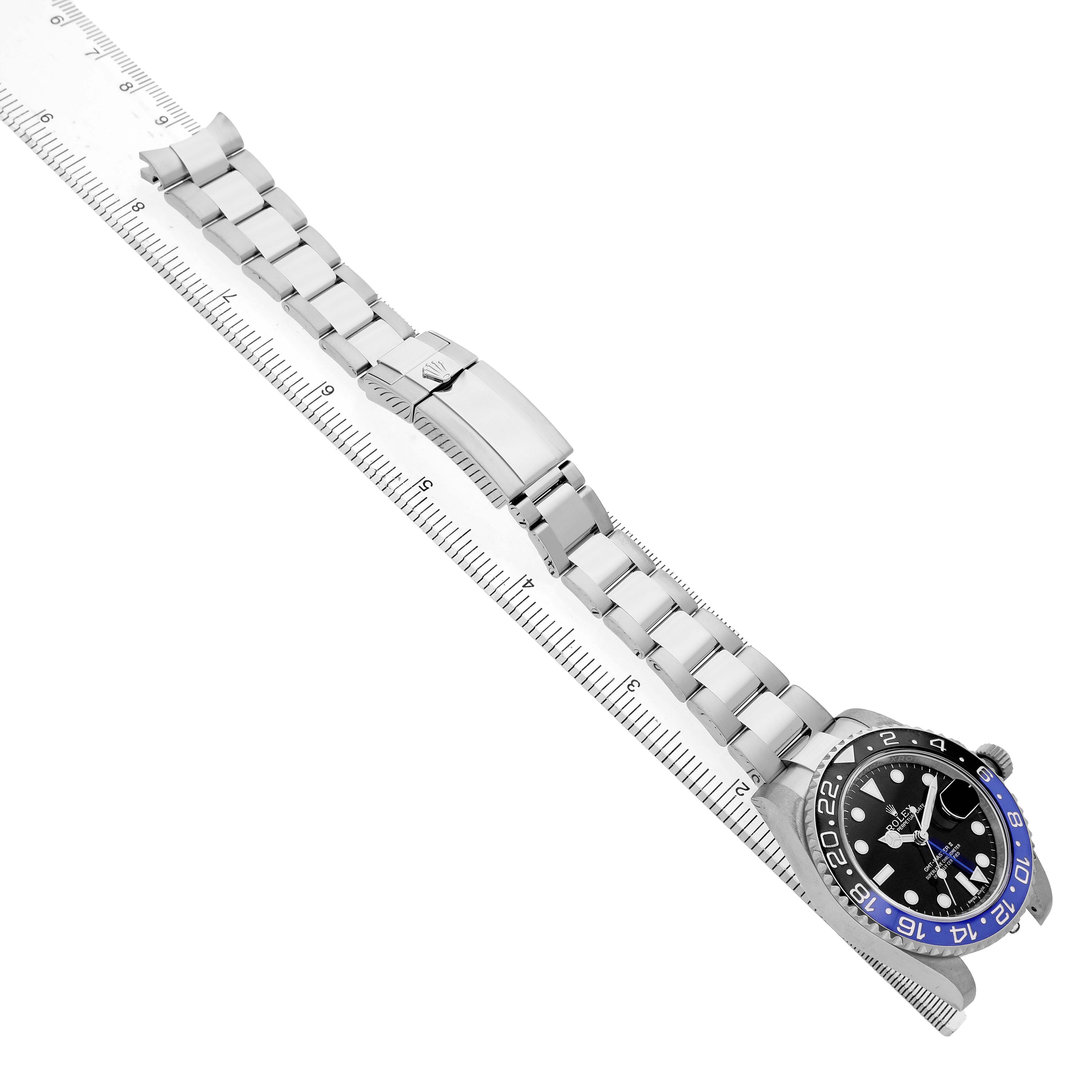 The Rolex GMT-Master 116710BLNR Men's Stainless Steel Black Dial is shown at an angle, displaying the face, bezel, and metal bracelet alongside a measuring ruler.