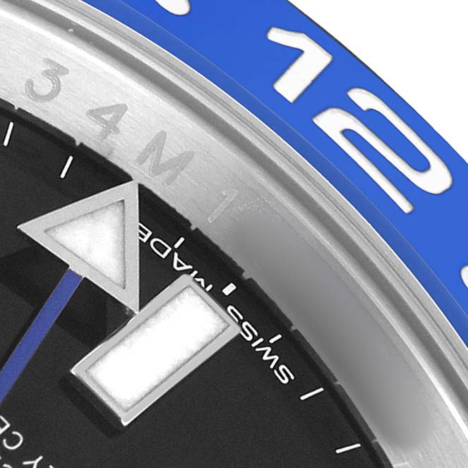 The image shows a close-up of the bezel and dial of a Rolex GMT-Master 116710BLNR Men's Stainless Steel Black Dial, focusing on the hour markers and part of the blue bezel.