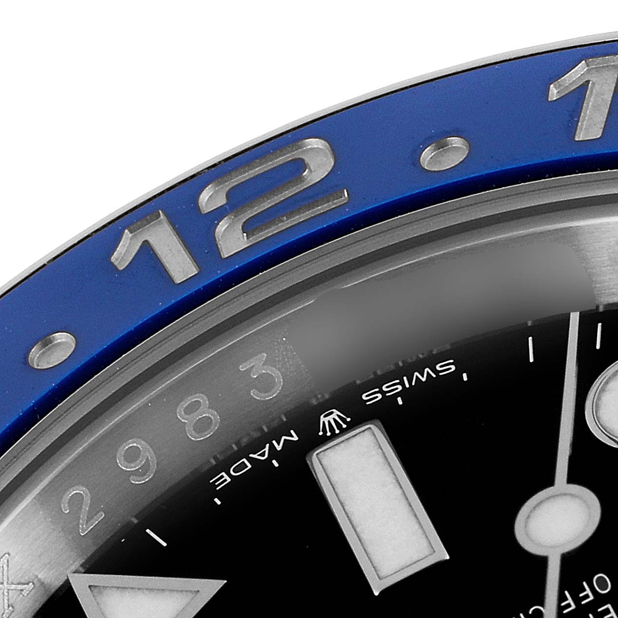The image shows a close-up of the bezel and part of the dial of a Rolex GMT-Master 126710 Men
s Stainless Steel Black Dial 126710 Men
s Stainless Steel Black Dial watch, focusing on the 12 marker and "Swiss Made" text.