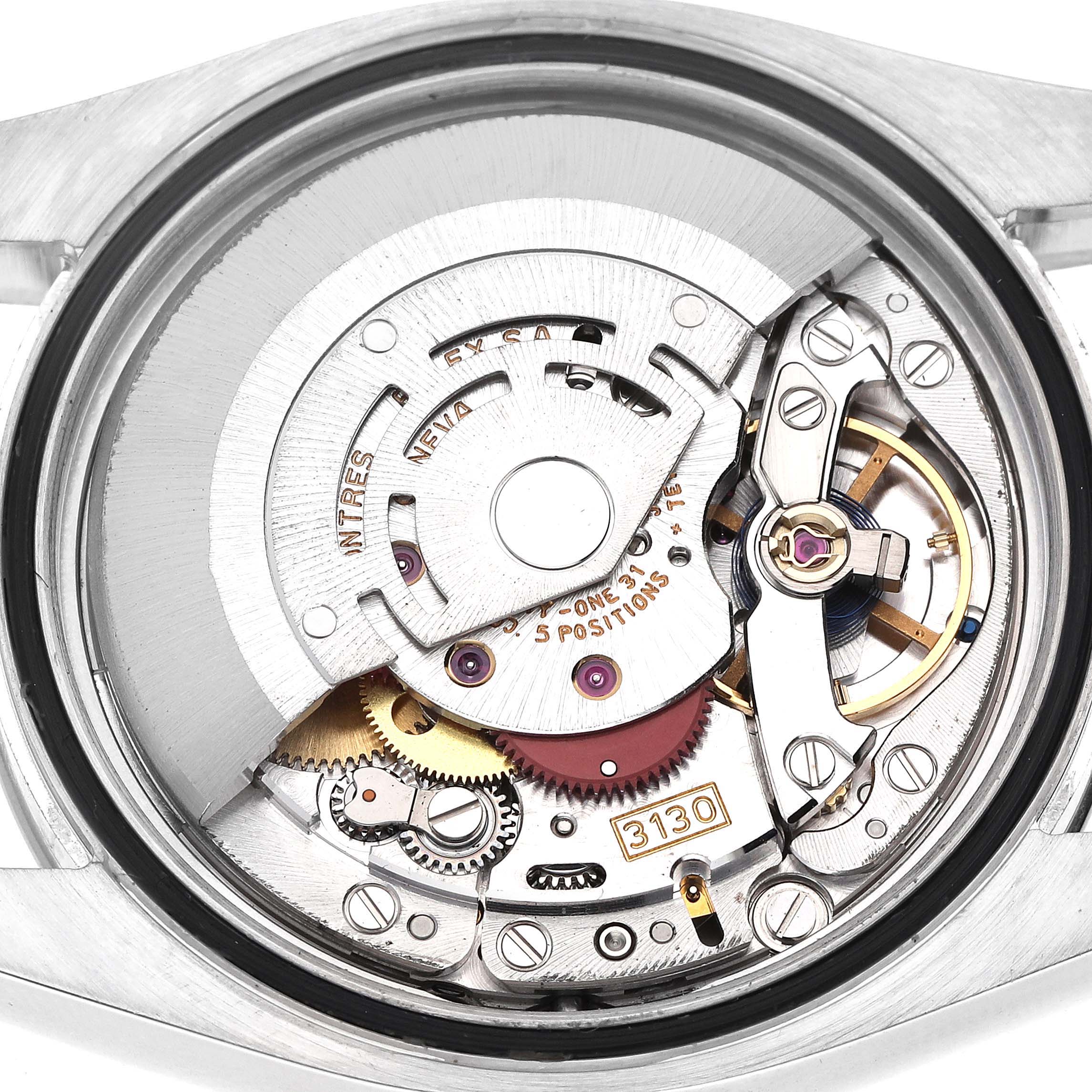 The image shows the inner mechanical movement of a Rolex Oyster Perpetual 116000 Men's Stainless Steel Black Dial watch, viewed from the back.