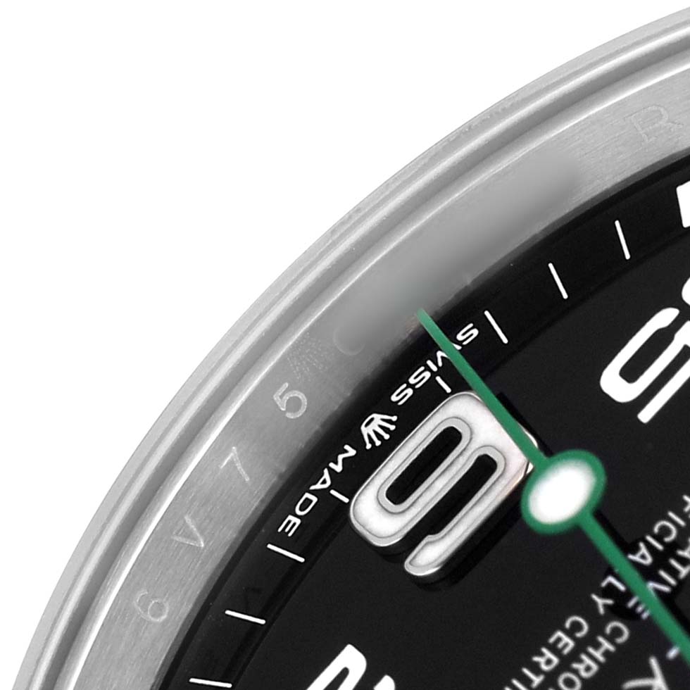 The image shows a close-up of the dial and bezel edge of the Rolex Air-King 126900 Men's Stainless Steel Black Dial, focusing on the numeral and green hand.