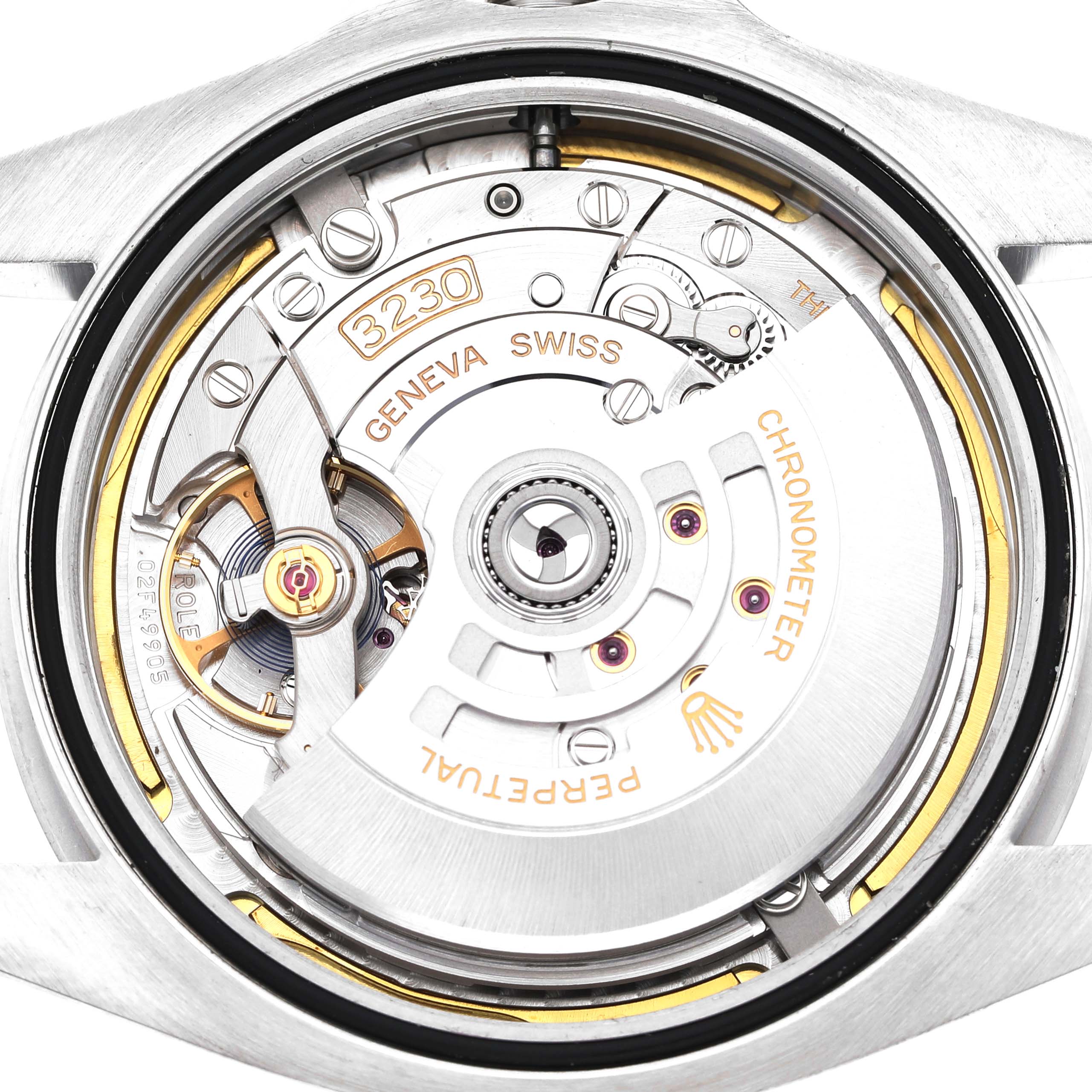 The image shows the back view of the Rolex Air-King 126900 Men's Stainless Steel Black Dial, highlighting its movement and internal mechanisms.
