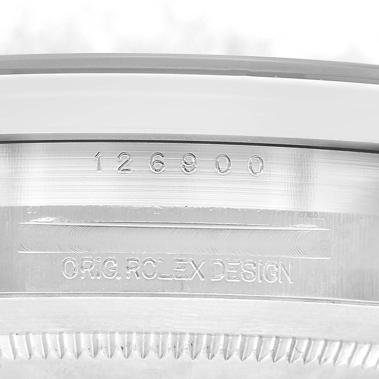 The image shows a close-up of the side of a Rolex Air-King 126900 Men's Stainless Steel Black Dial watch, revealing the model number and "Orig. Rolex Design" engravings.