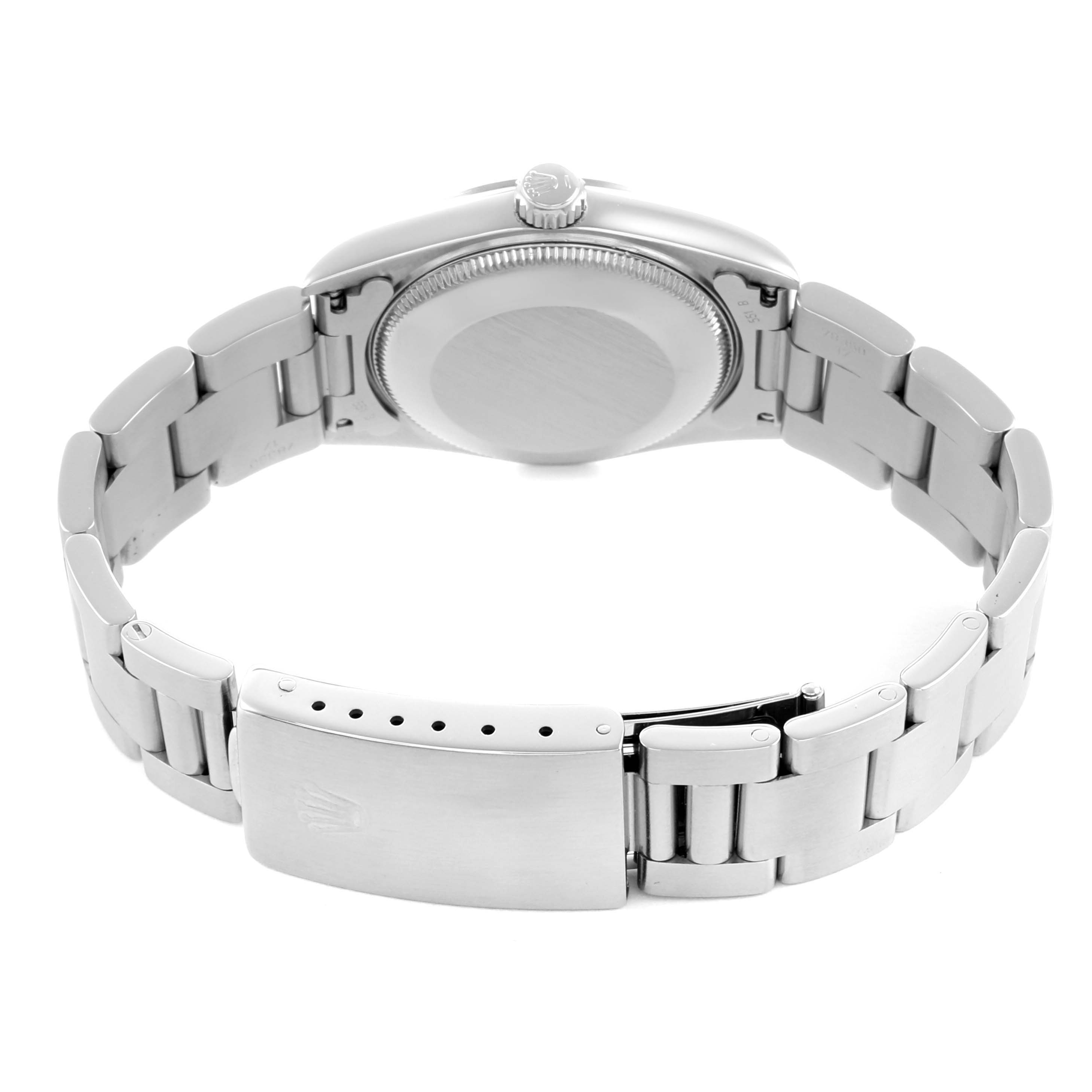 The Rolex Oyster Perpetual 67480 Women's Stainless Steel White Dial is shown from the back, highlighting the clasp, bracelet, and case back.