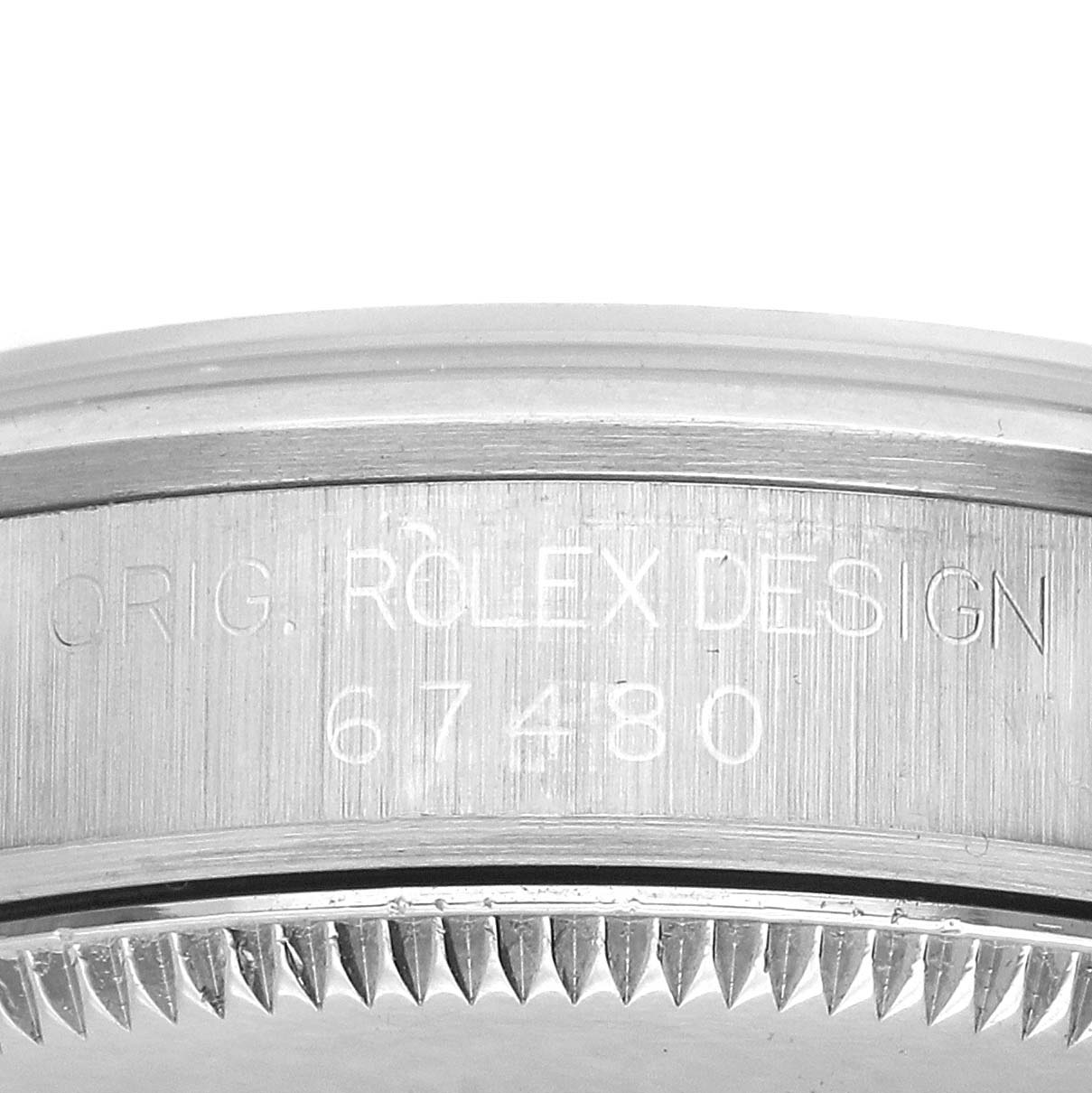 The image shows a close-up of the side of a Rolex Oyster Perpetual 67480 Women's Stainless Steel White Dial, highlighting the engraved "ORIG. ROLEX DESIGN" and model number.
